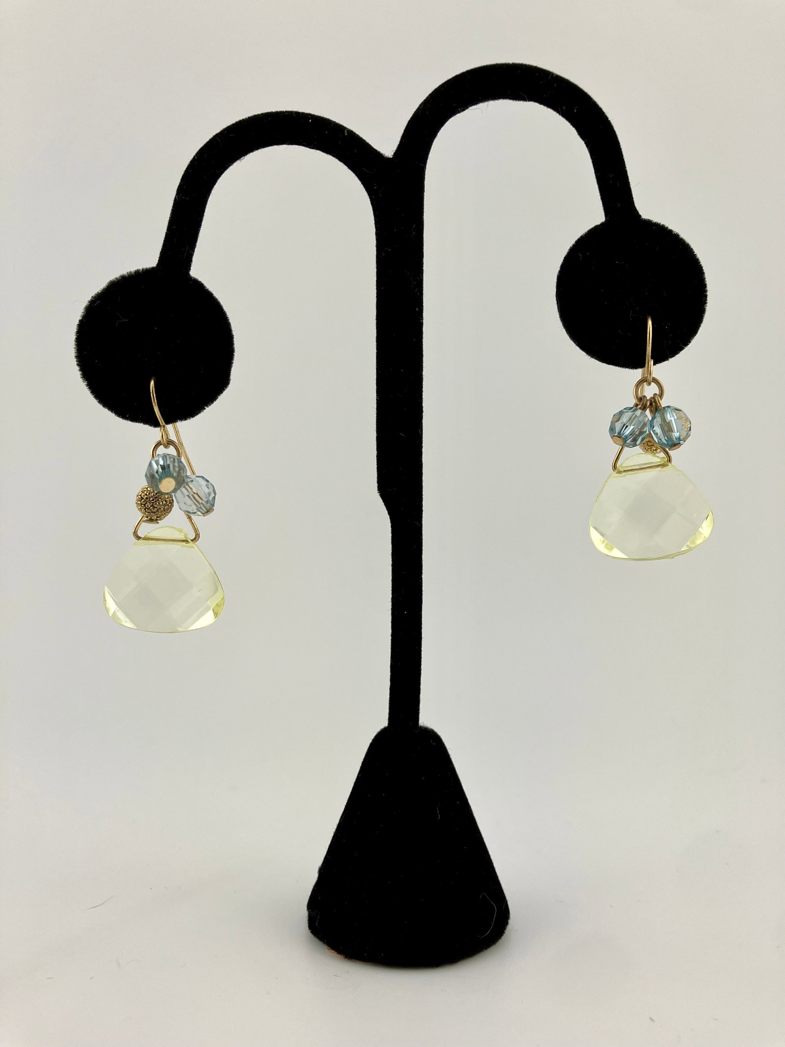 Comer Neal yellow topaz and blue stone wire pierced earrings: Comer Neal pierced earrings. Gold twisted wire with pale yellow topaz and blue stones. 1.25".