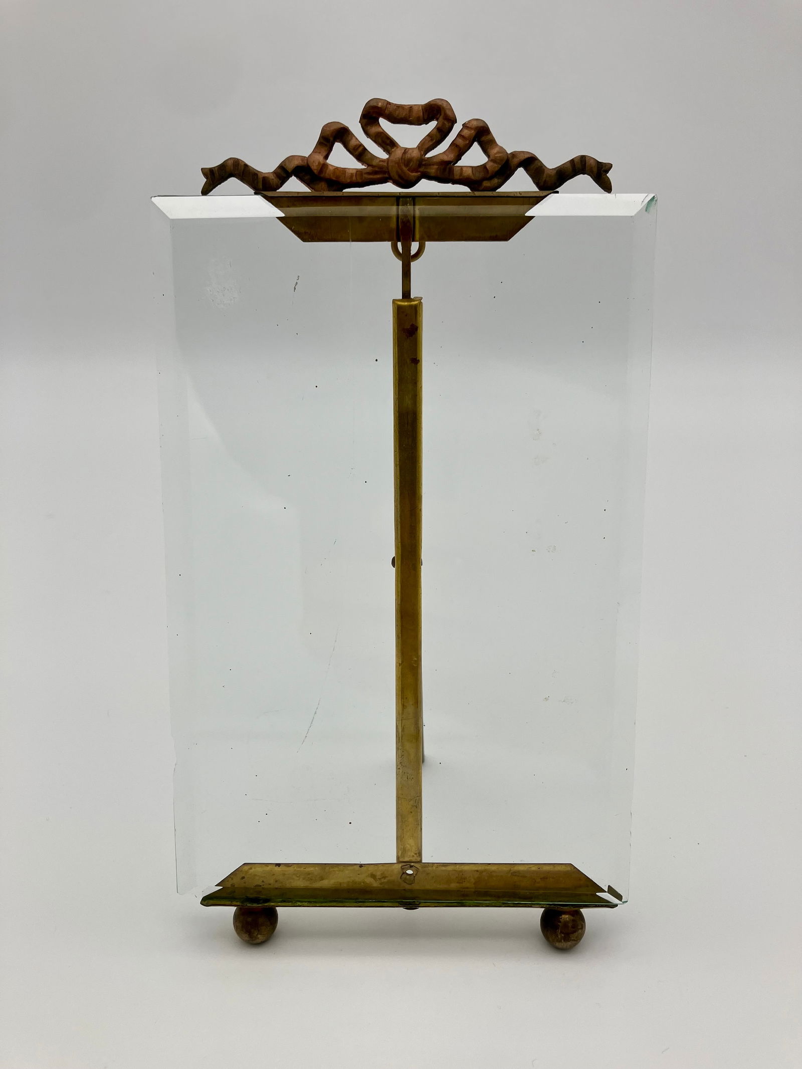 20th C French Glass and Gilt Easel Picture Frame 4x6": 20th c. French Easel Picture Frame. Floating beveled glass. Reticulated ribbon adornment at the top of the frame. Excellent condition. Dimensions: 4x6in