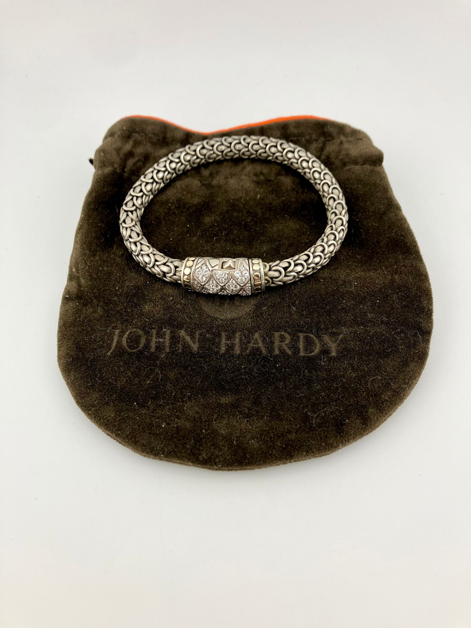 John Hardy Diamond Legends Naga Bracelet: Sterling silver and 18k gold bracelet from Hardy’s Naga Collection. Bracelet measures 8” long and weighs 55g.