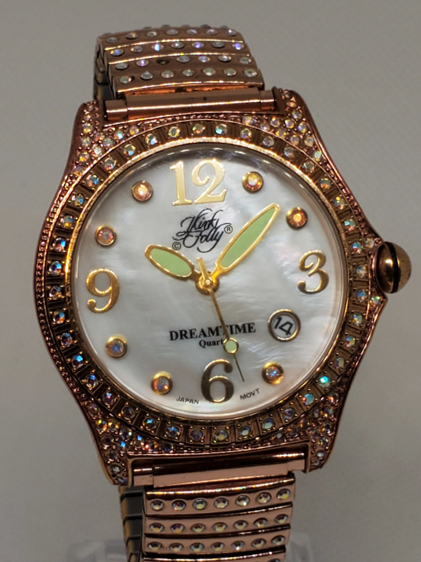 Kirks Folly Mother of Pearl Rose Gold Dreamtime Watch, 2000s - Vintage Collection -: Add a touch of whimsical elegance to your collection with the Kirks Folly KF584 Dreamtime watch -running-. This stunning timepiece showcases a dazzling mother-of-pearl dial with a date function, surro