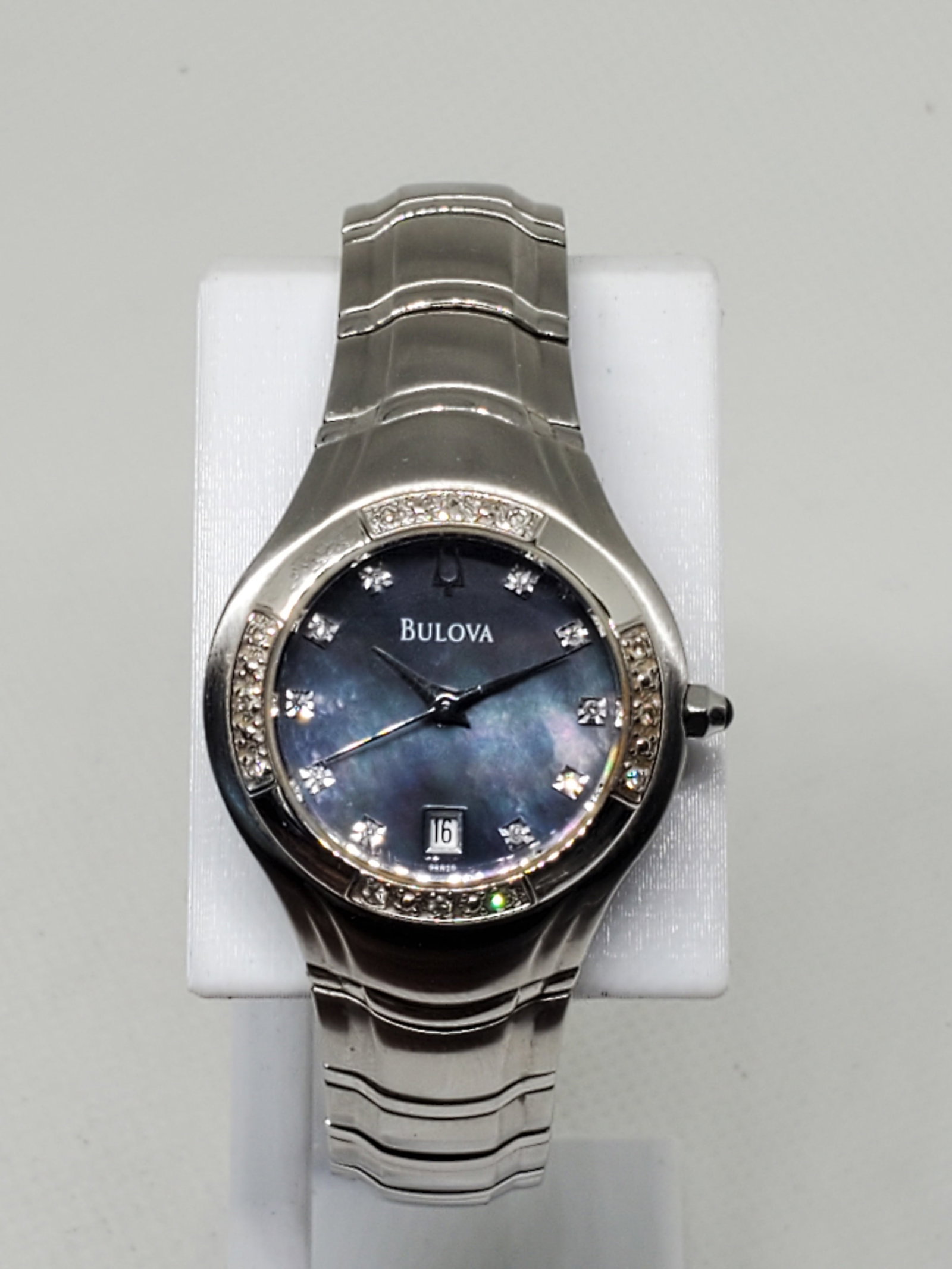 Bulova Green-Pink Mother of Pearl With Diamonds Ladies Watch, 2000s - Vintage Collection -: Experience timeless elegance and luxury with the Bulova A4 899076, a refined dress watch that exudes sophistication. Crafted with a sleek silver case and featuring a stunning green-pink mother-of-pear