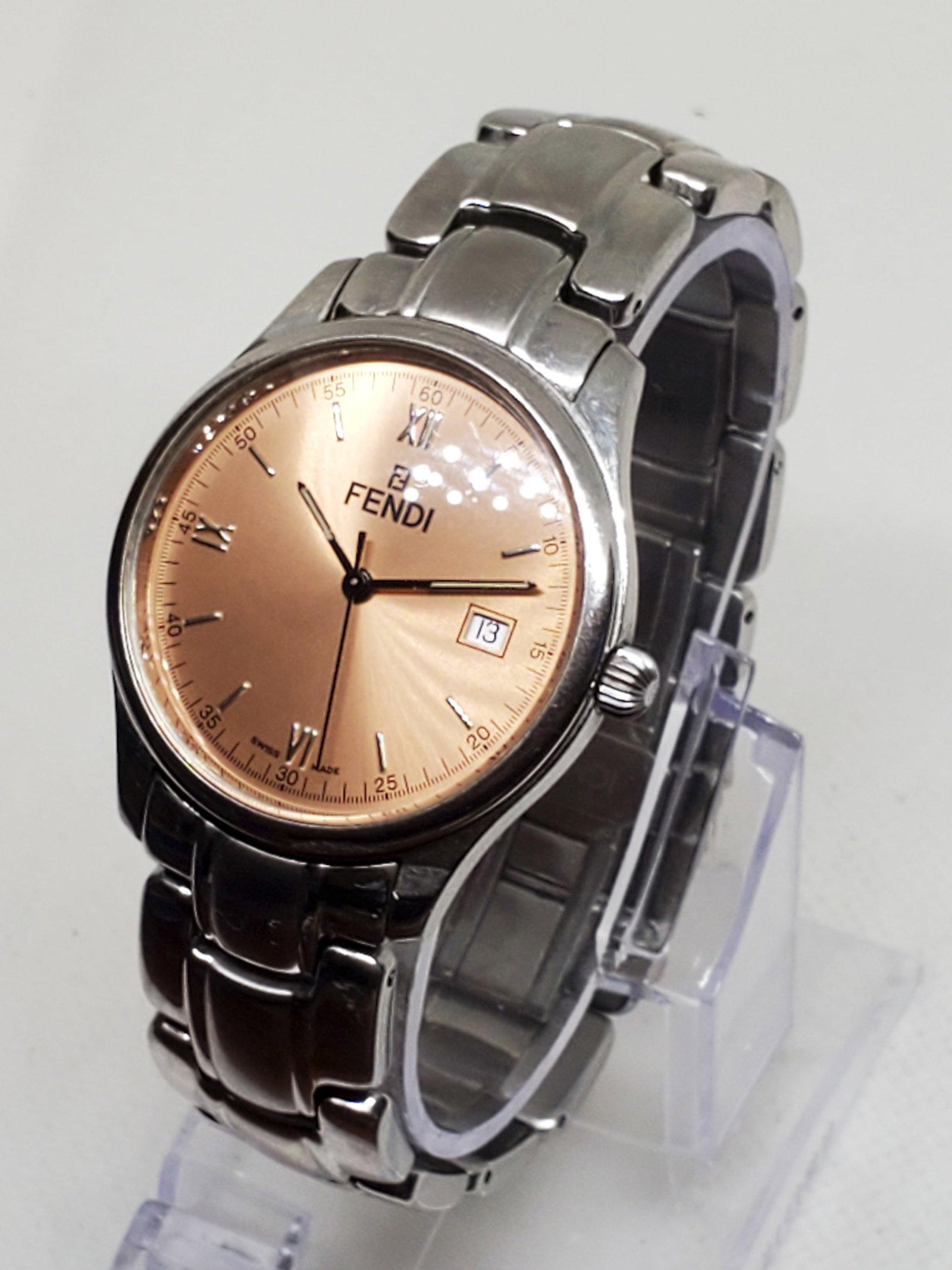Fendi Champagne Dial for Men Watch: Working condition Fendi 210C, a perfect blend of elegance and timeless sophistication. Crafted by the prestigious Fendi brand, this dress watch exudes refinement with its sleek silver-tone case and ca
