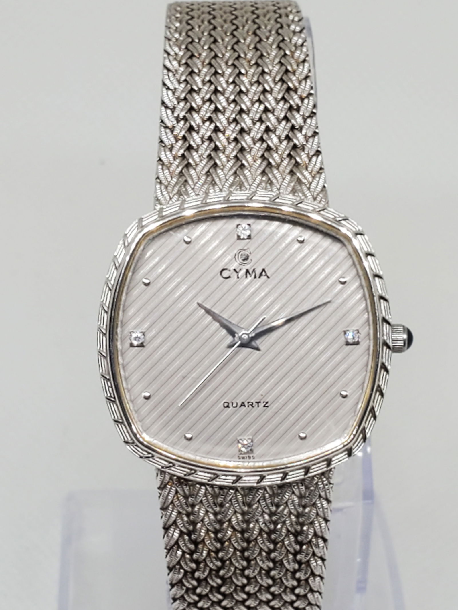 Cyma Dress Line Gilloche Unisex Watch, 1990s: Exude refined elegance with this Dress line Quartz timepiece, a watch that perfectly balances sophistication and everyday wearability. Featuring a silver-tone case with a finely crafted dual-tone silv