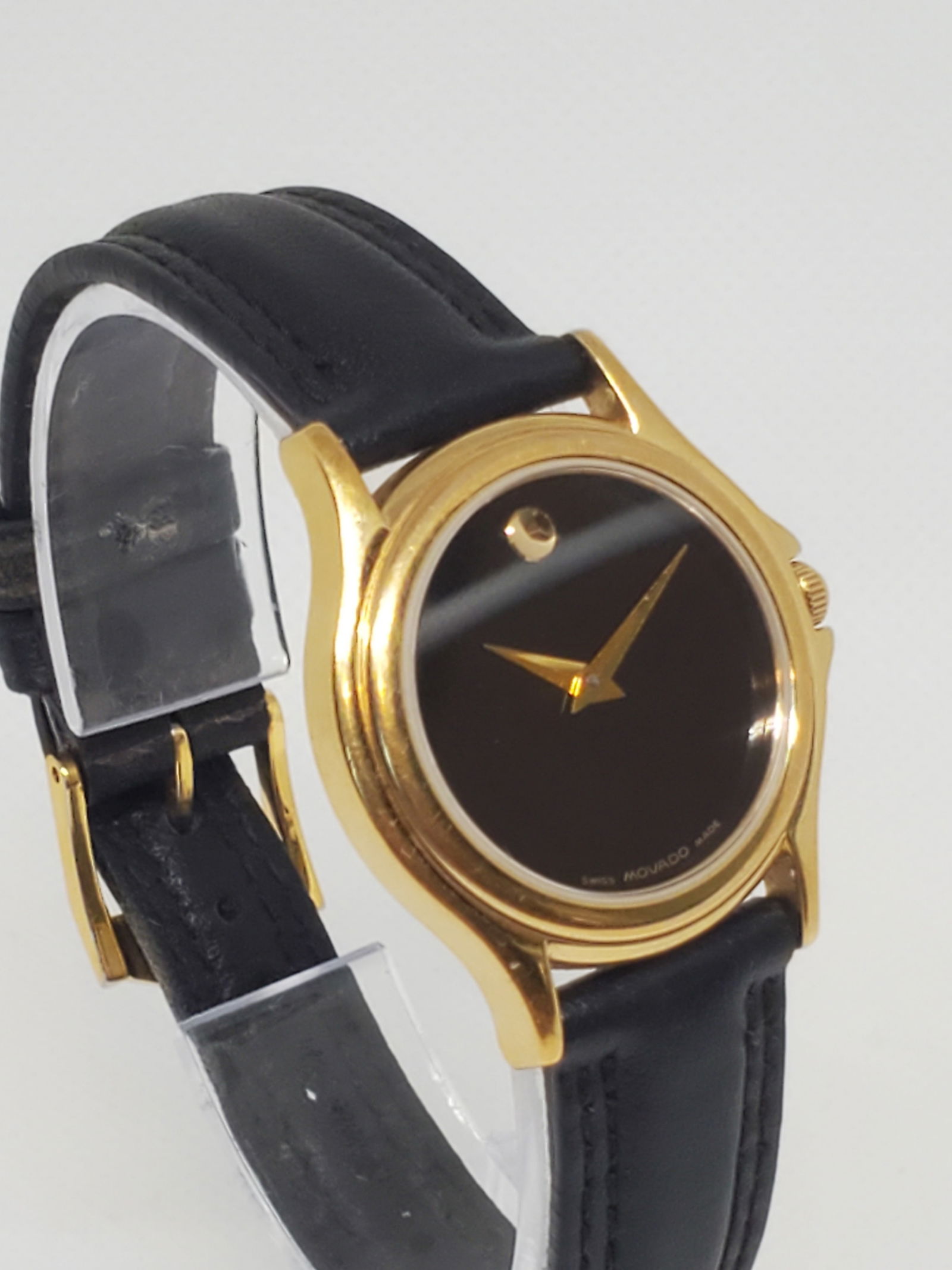 Movado Museum Gold Plated Watch, 1990s: This Movado Museum watch in working condition exudes timeless elegance and luxury, a must-have for collectors and those who appreciate understated sophistication. Its gold-plated circular case 1.1" (2