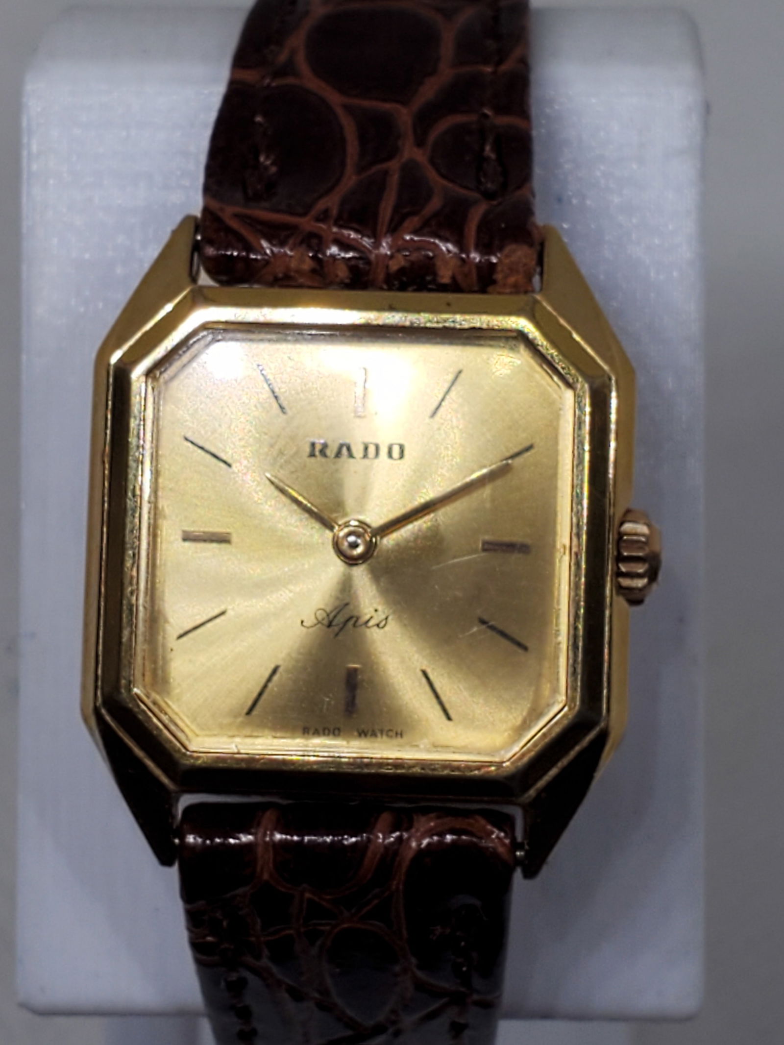 Vintage Rado Apis Gold Tone Dress Watch Swiss Quartz K1174720 Elegant Classic, 1980s: This vintage Rado Apis exemplifies the refined Swiss craftsmanship that made Rado a symbol of enduring elegance and precision. Featuring a distinctive octagonal gold plated case paired with a sunburst