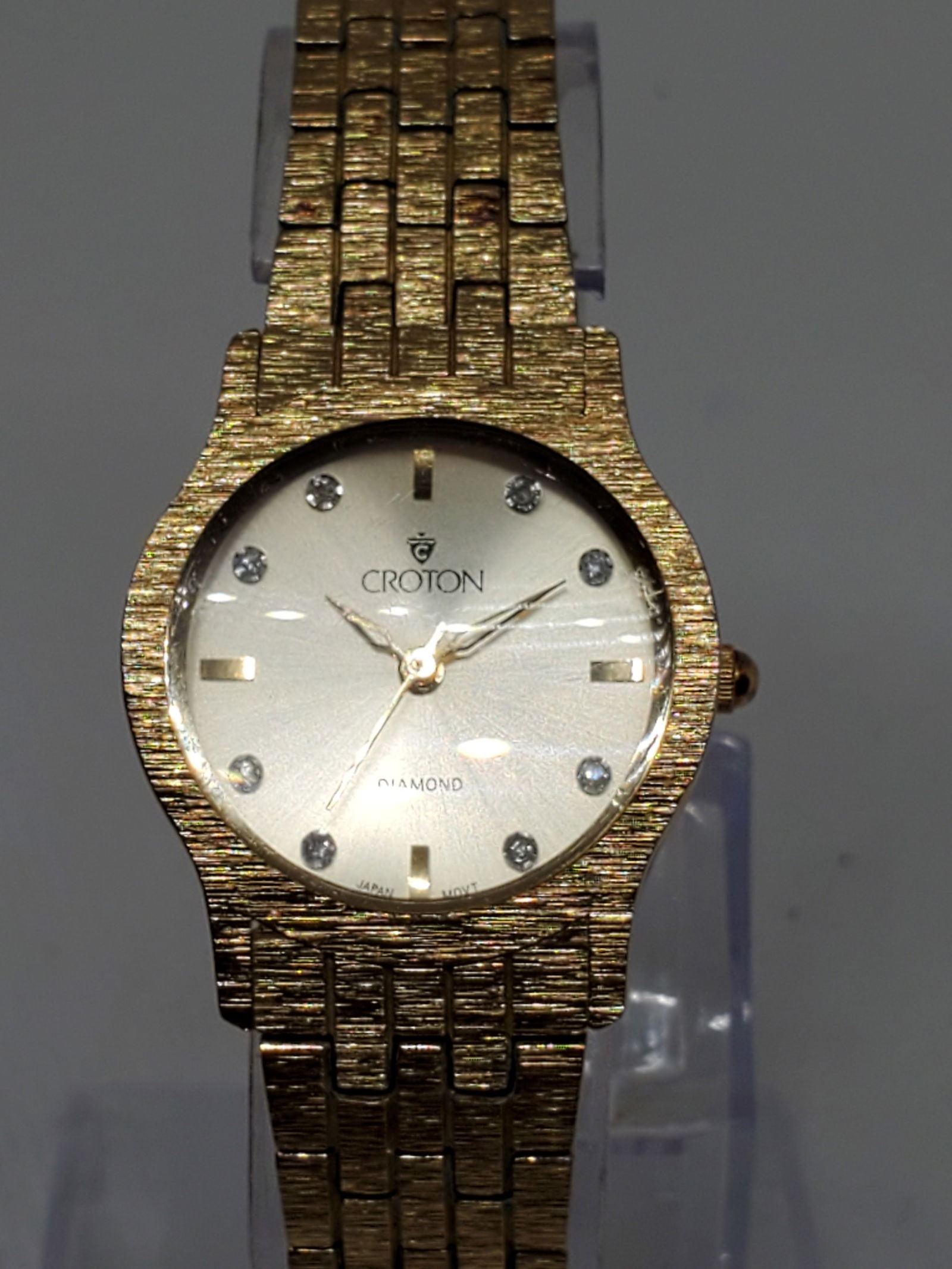 Croton Gold Plated Watch with Diamond Markers, 1990s: Croton Diamond watch in operation, a true statement piece for those who appreciate luxury and precision. The gold plated case and gold tone dial, adorned with eight genuine diamond markers, create a s