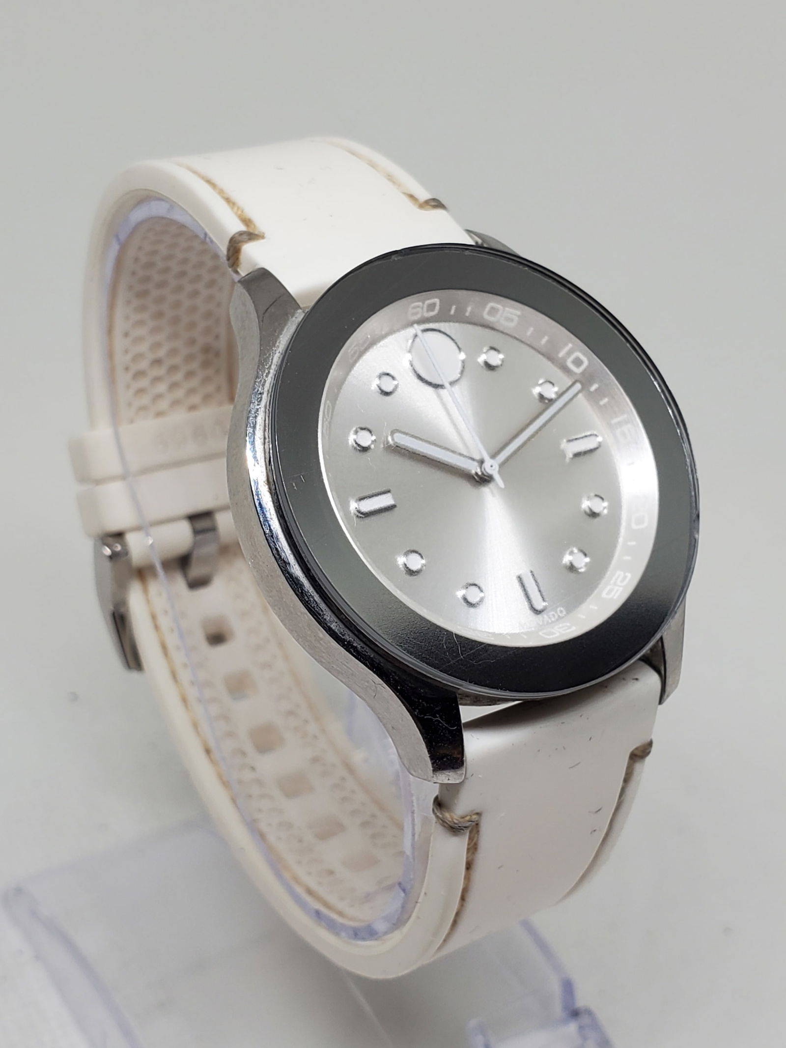 Movado Bold Silver Dial 36mm Watch Stainless Case White Strap Model 14.692.797, 2014-2017: This Movado Bold model 14.692.797 showcases the modern elegance and minimalist prestige that have defined Movado since its founding by Achille Ditesheim in 1881 in La Chaux de Fonds Switzerland. Known