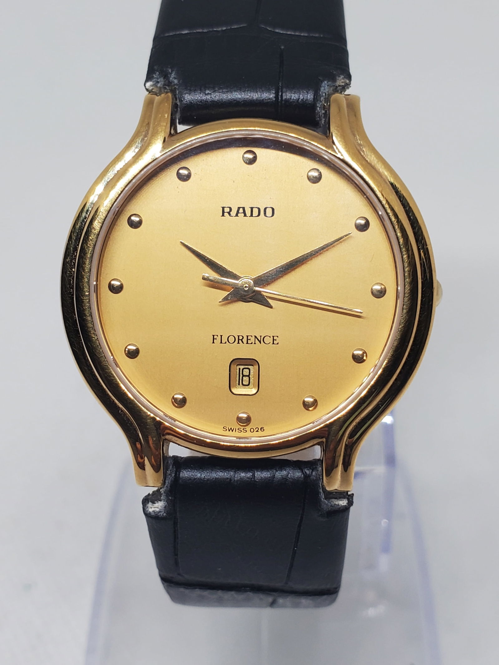 Rado Florence Gold Dial Quartz Dress Watch Sapphire Crystal Swiss Made, 1990s: This elegant Rado Florence dress watch showcases the refined minimalism and prestige for which the brand is known, featuring a gold plated case paired with a warm gold dial accented by discreet applie