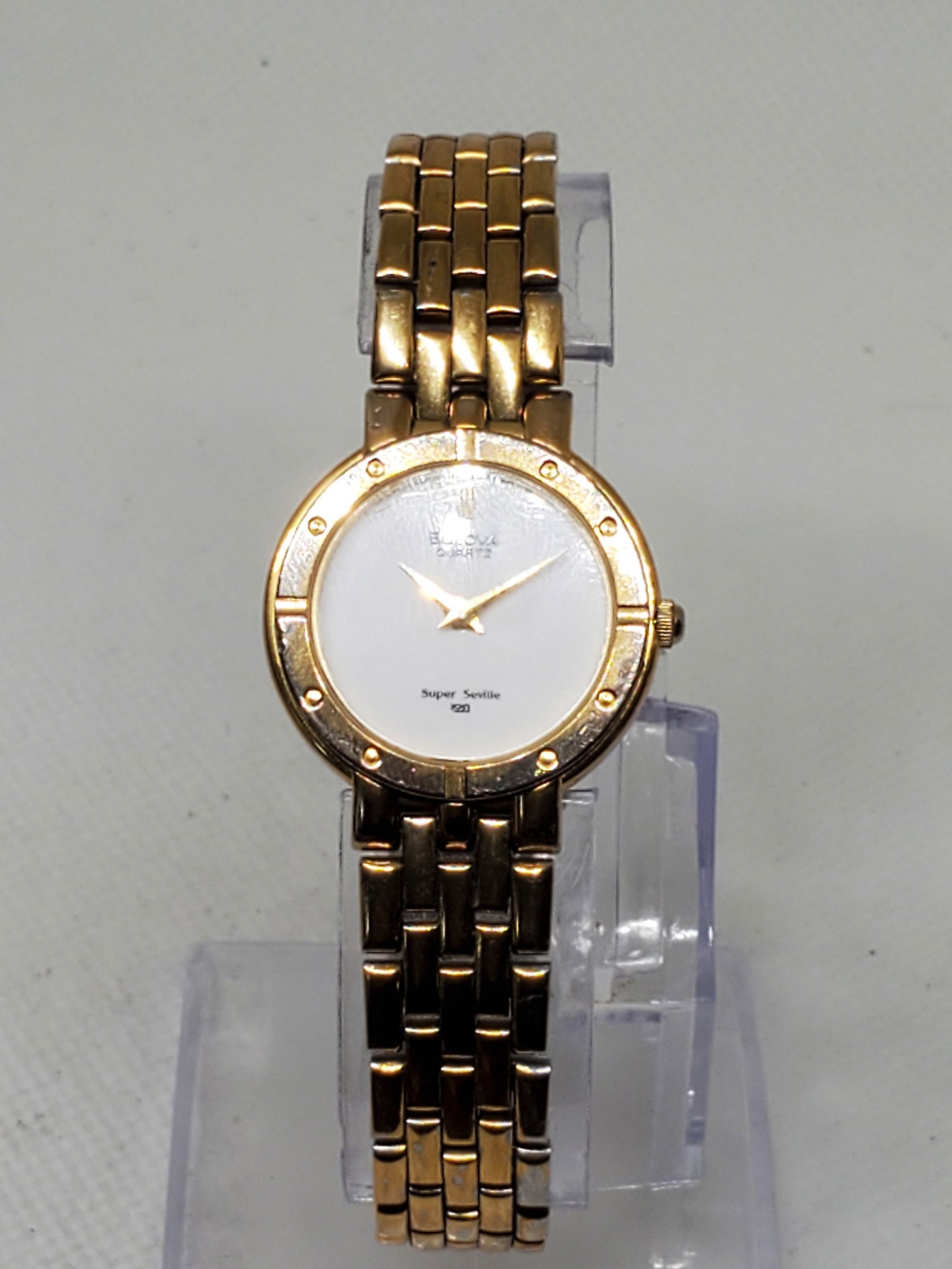 Bulova Super Seville Gold Plated Ladies Watch, 1980s: Experience the refined elegance of the Bulova Quartz Super Seville, model 839401140. This sophisticated dress watch features a gold plated case paired with a pristine white dial, exuding timeless char