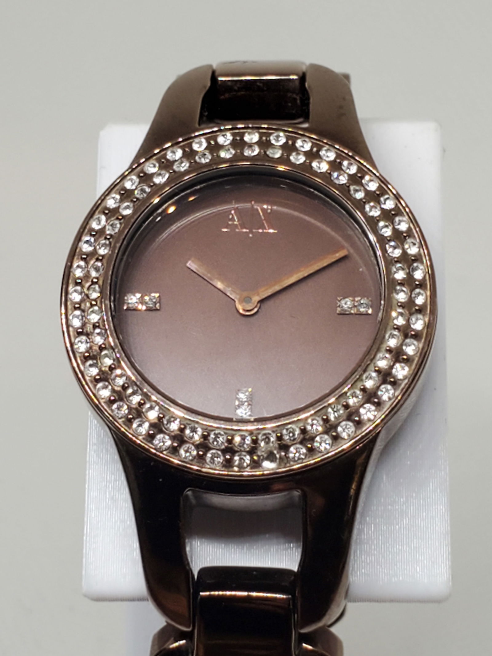 Armani Exchange Bronze Rose Gold with Rinestones Watch, 2010s: Working condition Armani Exchange AX4097, a stunning watch designed to elevate your wardrobe. Featuring a gorgeous bronze rose gold case adorned with dazzling rhinestones on the bezel, this timepiece
