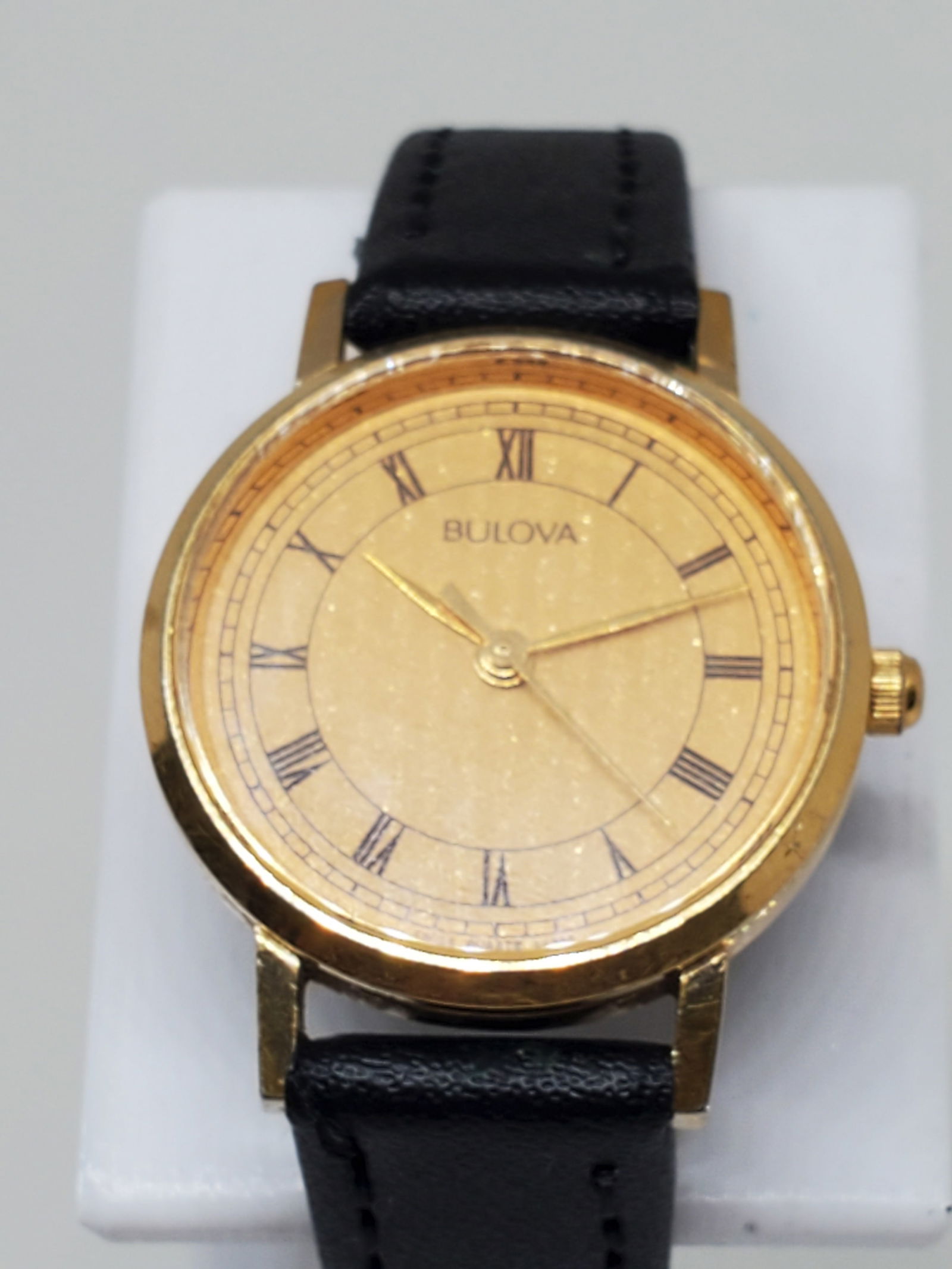 Bulova Gold Plated Ladies Watch, 1980s: Experience timeless sophistication with this Bulova P4 dress watch, a refined piece designed for elegance and reliability. The gold plated case and gold dial with classic Roman numerals evoke a sense