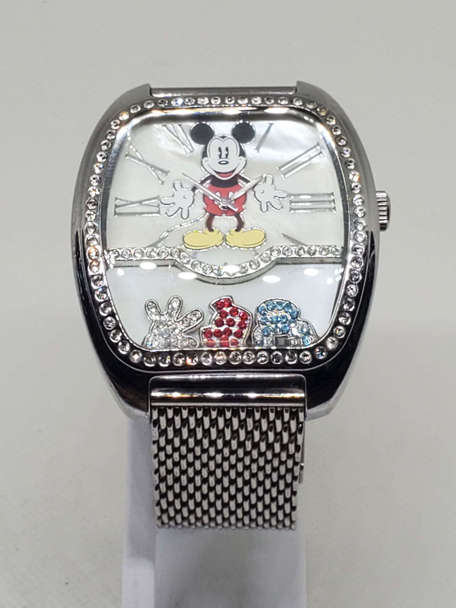 Disney T&G Mickey Mouse Mother of Pearl Watch with Crystal Accents 44mm, 2000s: This charming Disney T&G (Time & Gems) Mickey Mouse MC 5G1386S Quartz Watch captures the perfect blend of playful artistry and timeless design. Featuring a silver tone stainless steel case adorned wit
