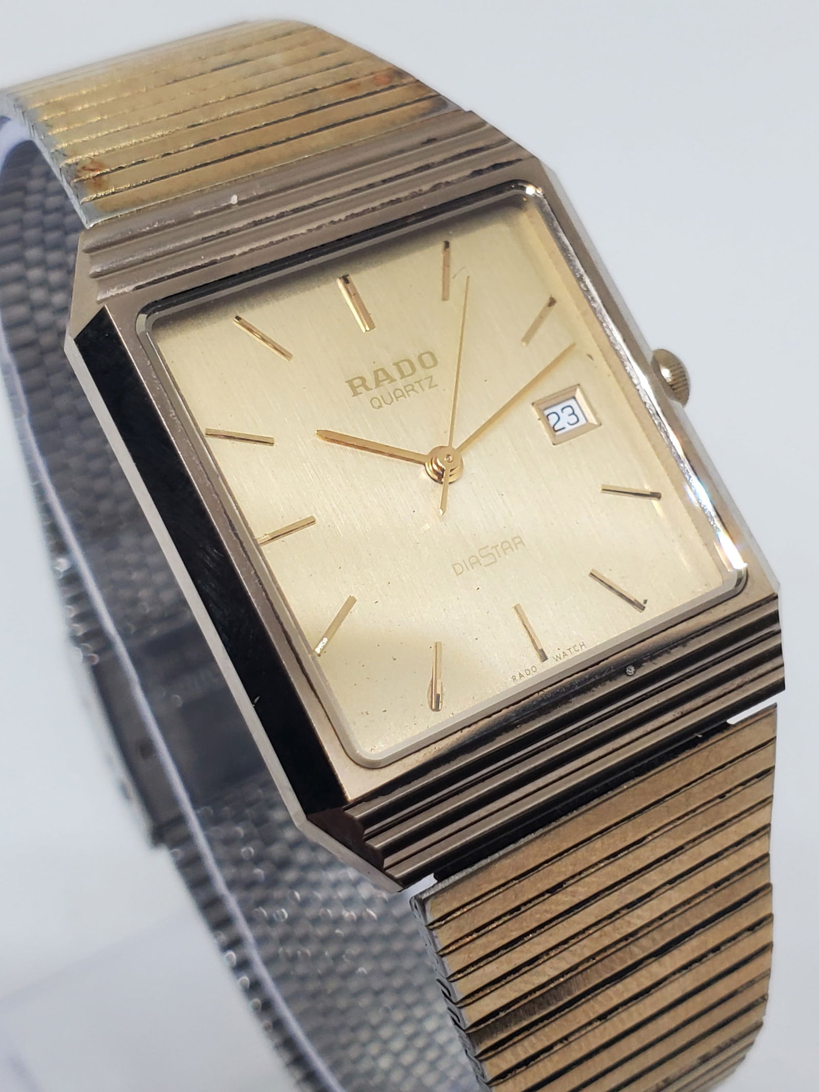 Rado DiaStar Tungsten Gold Dial Quartz Dress Watch Swiss Vintage, 1995: This elegant Rado DiaStar 129.9523.3 showcases timeless prestige with its iconic tungsten carbide case, refined gold dial, slim gold markers, and practical date function, delivering exceptional scratc