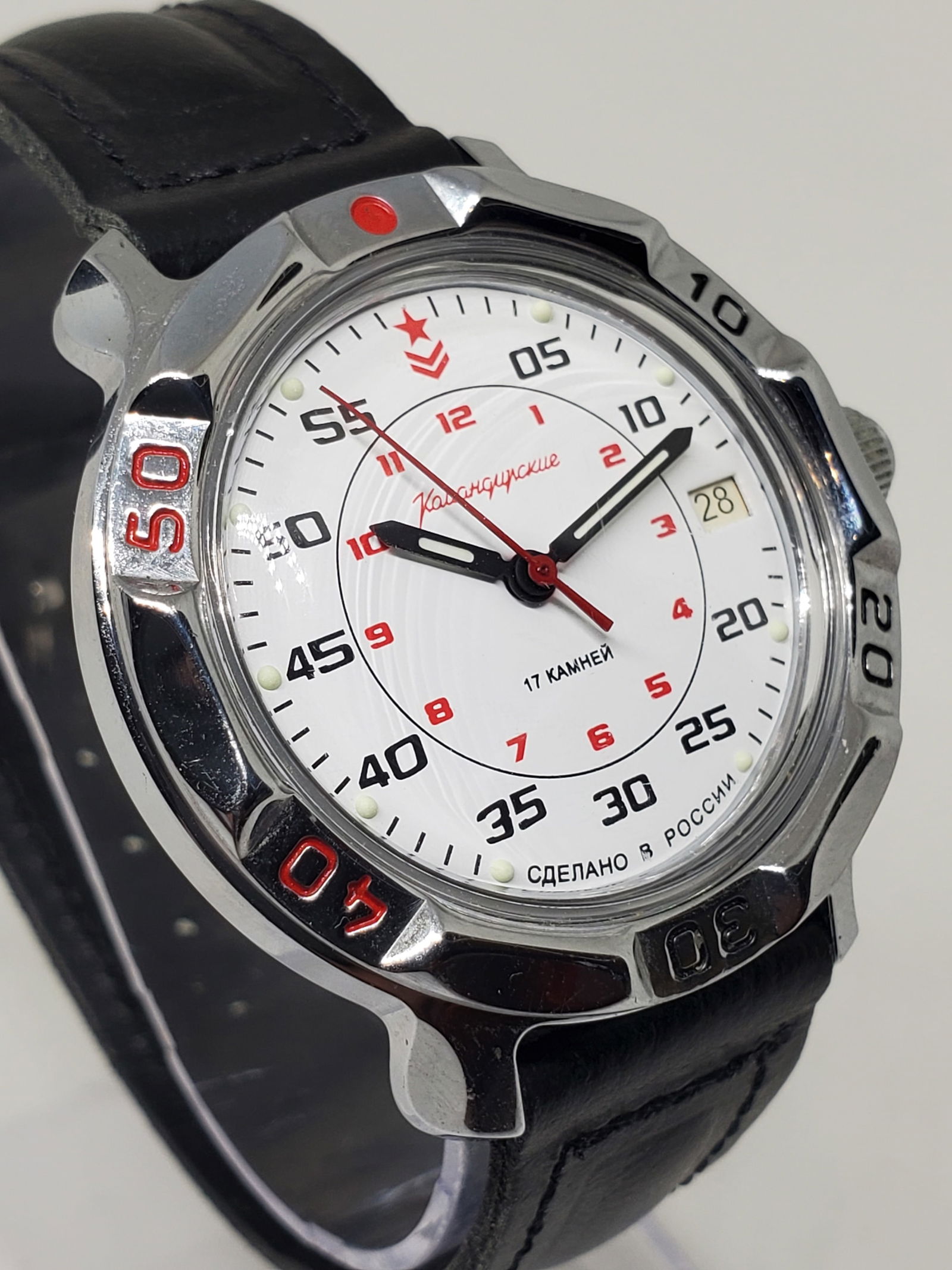 Vostok Komandirskie Automatic Russian Military Style Date Watch, 1998: This Vostok Komandirskie dress watch blends classic Russian military character with everyday elegance, featuring a silver tone case, a turning bezel, and a crisp white dial with date function inspired
