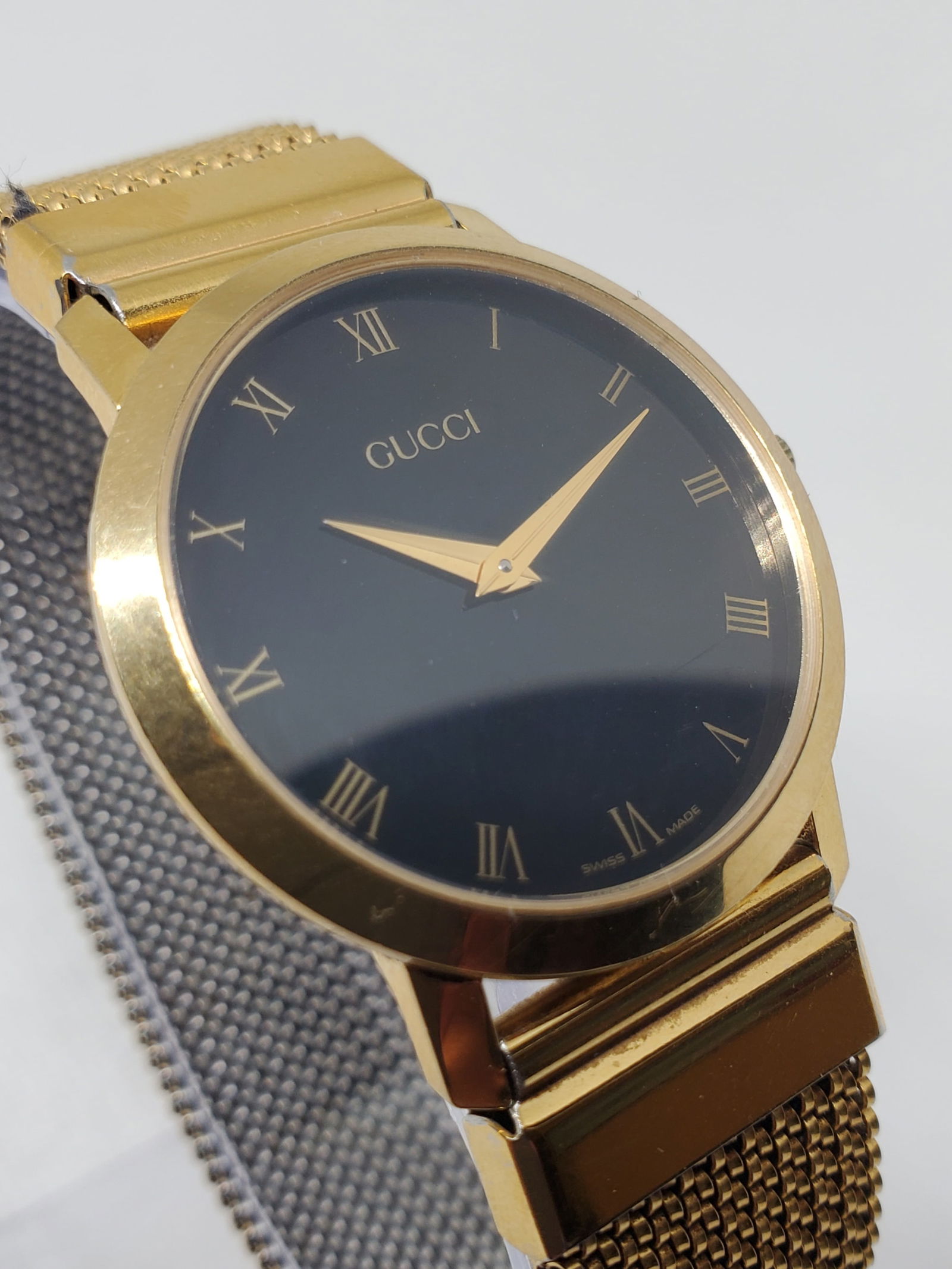 Gucci 2200M Gold Plated Black Dial Roman Numerals Swiss Quartz Watch, 1990s: This Gucci 2000M dress watch exemplifies understated elegance and timeless prestige, reflecting Gucci?s refined Italian design philosophy paired with Swiss watchmaking reliability. Founded in 1921 in
