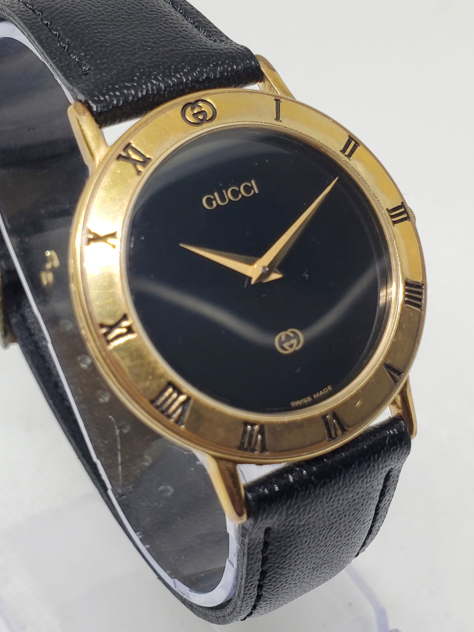 Vintage Gucci 3000M Black Dial Gold Plated Swiss Quartz Dress Watch, 33 mm, 1990s: This elegant Gucci 3000M dress watch exemplifies the refined minimalism and prestige that have defined Gucci timepieces for decades. Founded in 1921 in Florence Italy by Guccio Gucci the brand quickly
