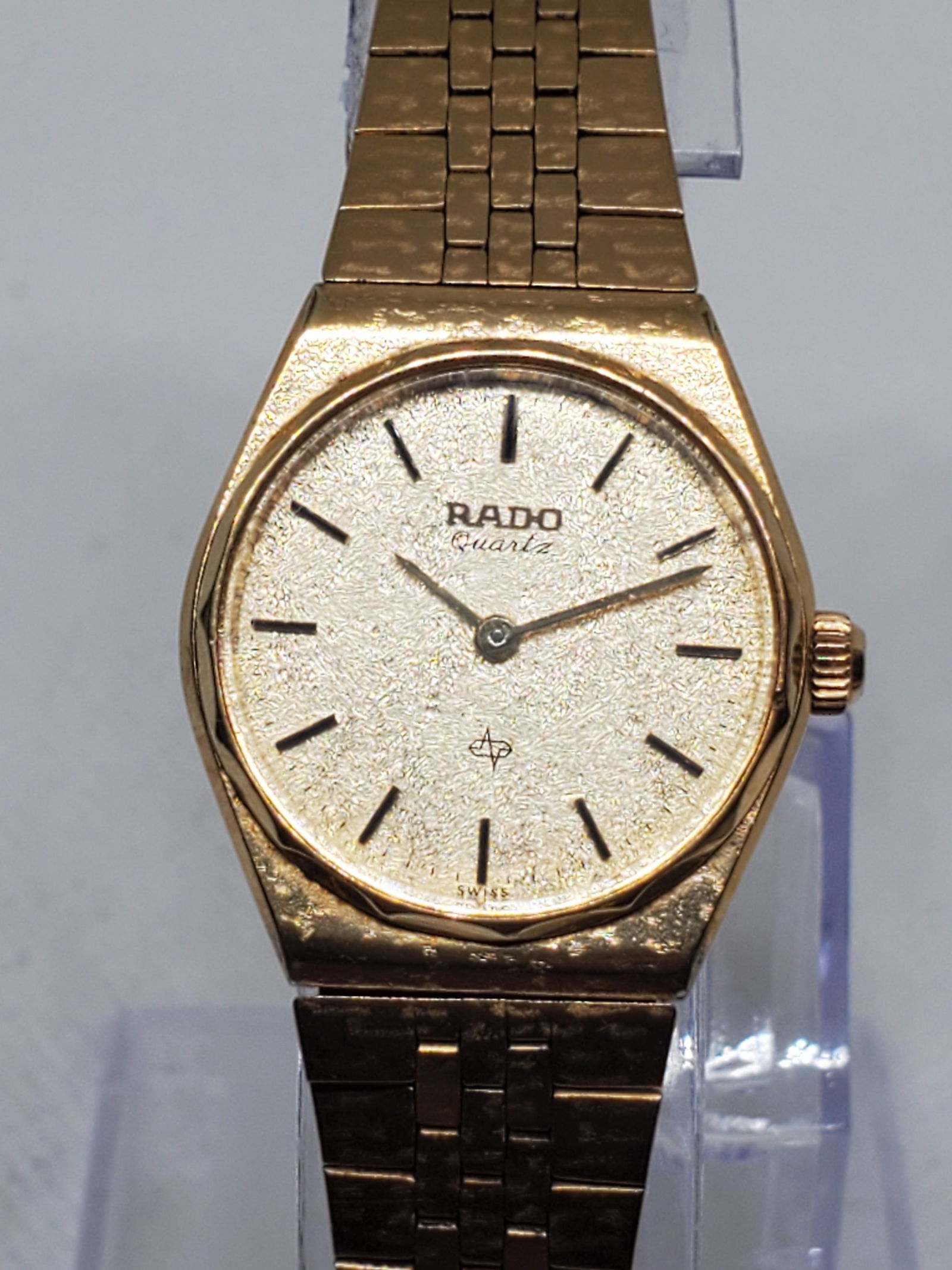 Vintage Rado 717.9011.2 Gold Plated Quartz Watch ? Frosted Dial Elegance, 1980s: This exquisite vintage Rado Quartz 717.9011.2 showcases the timeless sophistication that defines the Rado legacy. Featuring a gold plated case and a captivating frosted gold tone dial, this piece radi