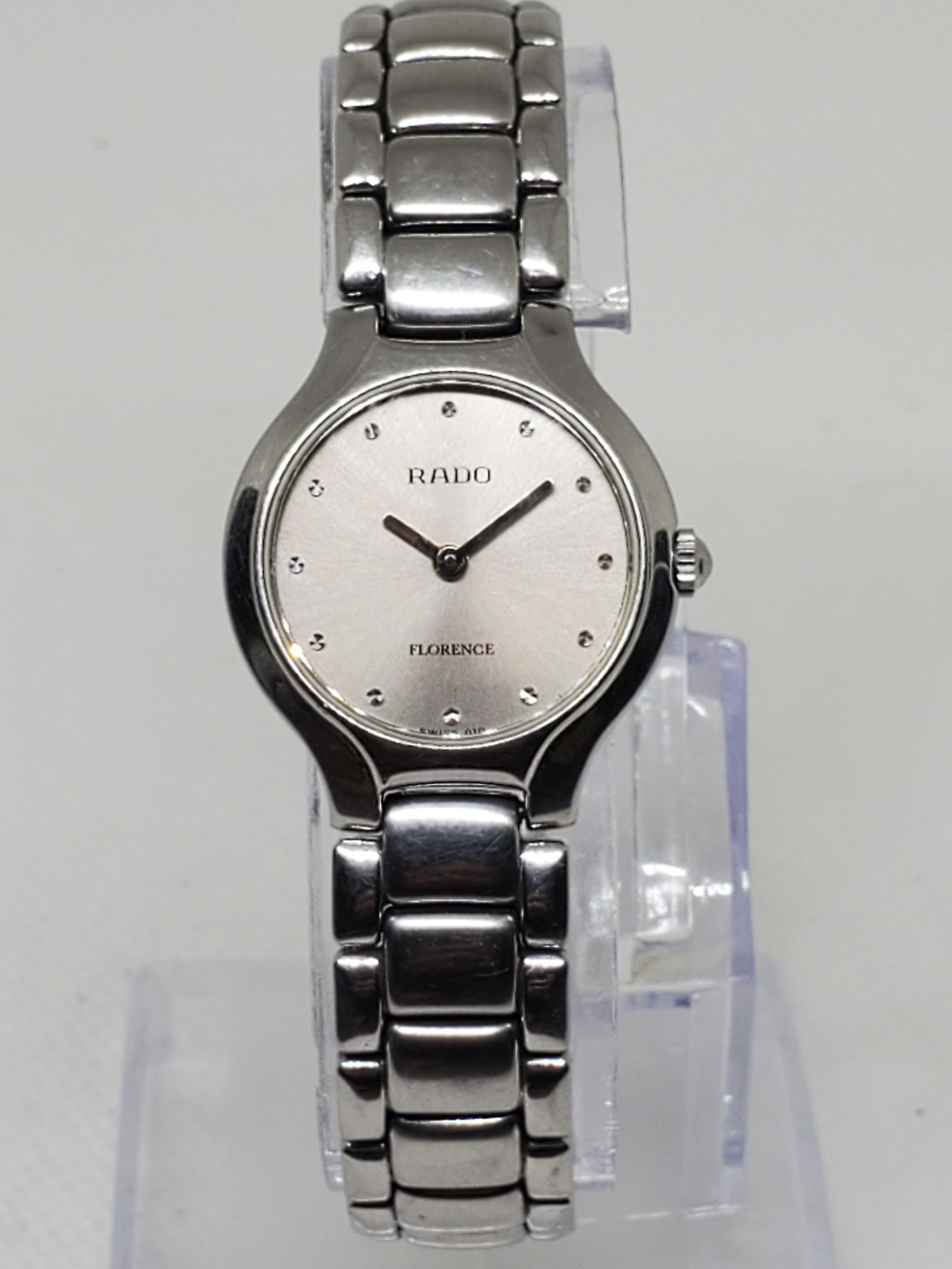 Rado Florence Silver Tone Ladies Watch, 1990s: This elegant Rado Florence embodies the timeless prestige of Swiss craftsmanship. Featuring a refined silver tone case and matching silver dial accented with minimalist diamond style hour markers, it