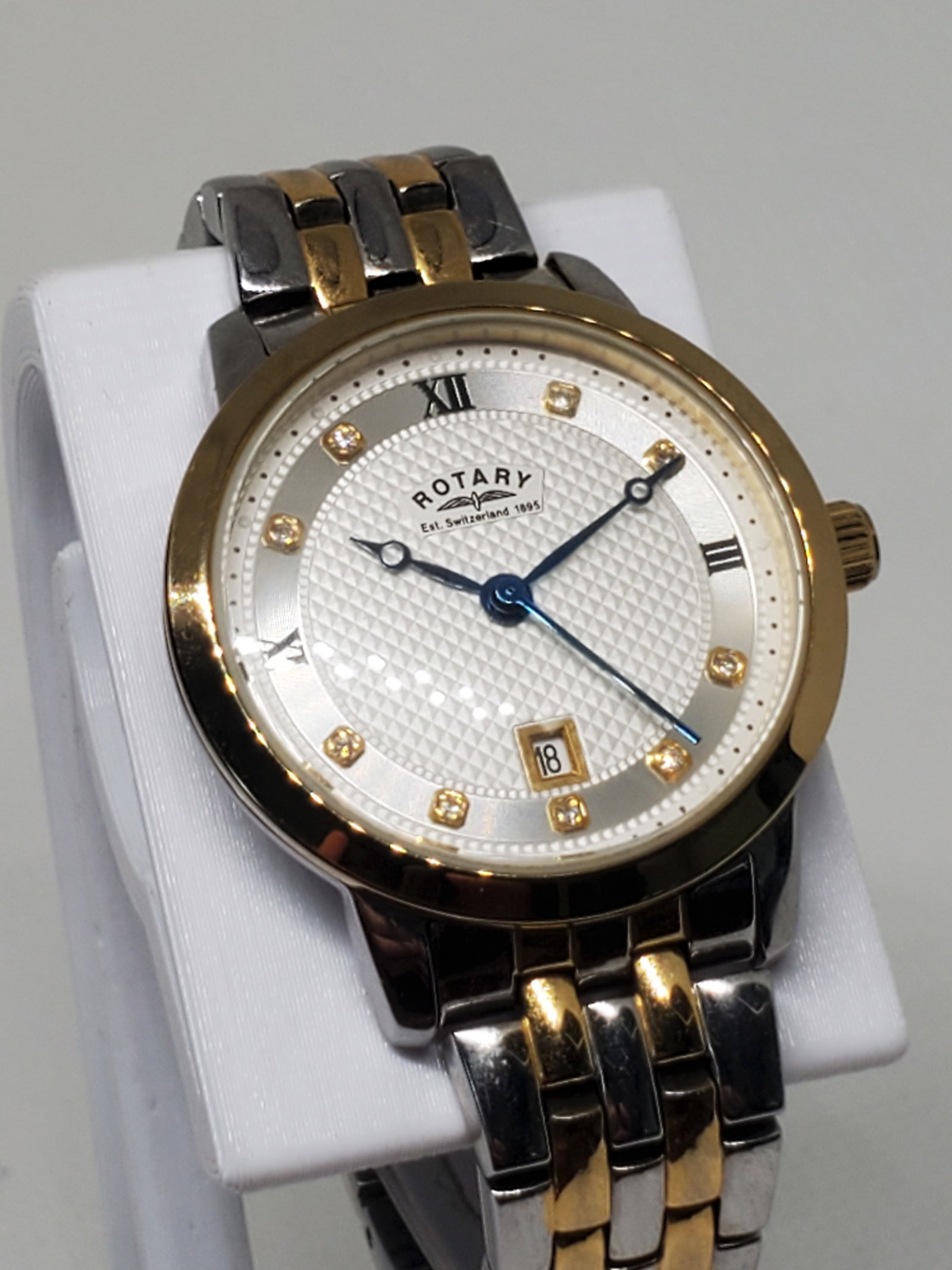Rotary Gold Plated Watch, 2000s: Working condition Rotary LB42826/41, a beautiful dress watch that exudes sophistication and class. With a gold plated bezel and a stylish metallic gold silver tone bracelet 5.5" wrist size, this watch