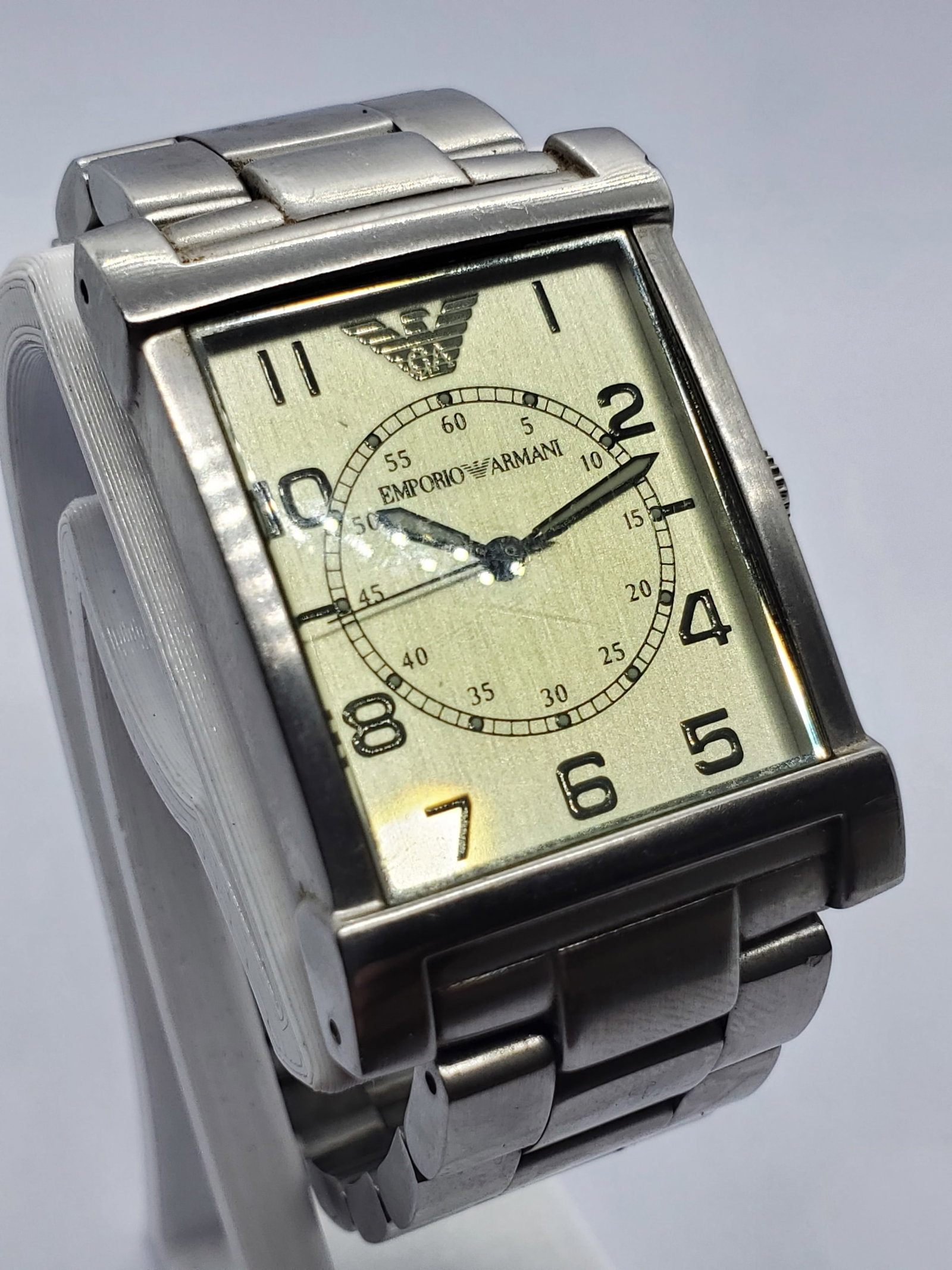 Emporio Armani Champagne Gold Dial Tank Dress Watch, 2000s: This Emporio Armani AR-0216 quartz dress watch reflects the refined Italian elegance and modern prestige that define the Emporio Armani brand, founded by Giorgio Armani in 1975 in Milan Italy and cele