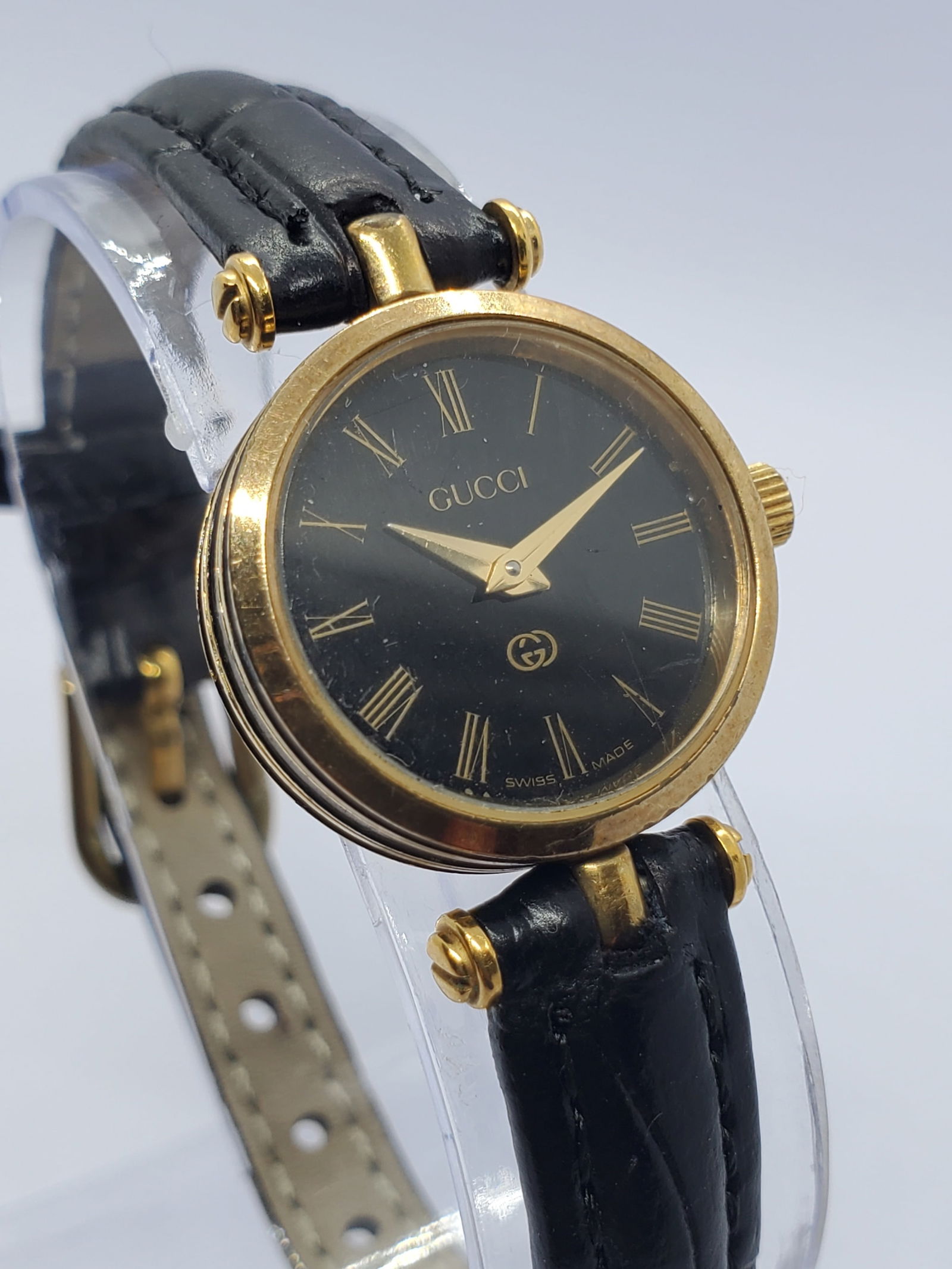 Gucci Sherry Line 2000L Gold Plated Black Dial Swiss Quartz Dress Watch, 1990s: This Gucci Sherry Line model 2000L exemplifies the understated elegance and prestige that have defined the brand for decades, featuring a gold plated case paired with a black dial accented by the icon