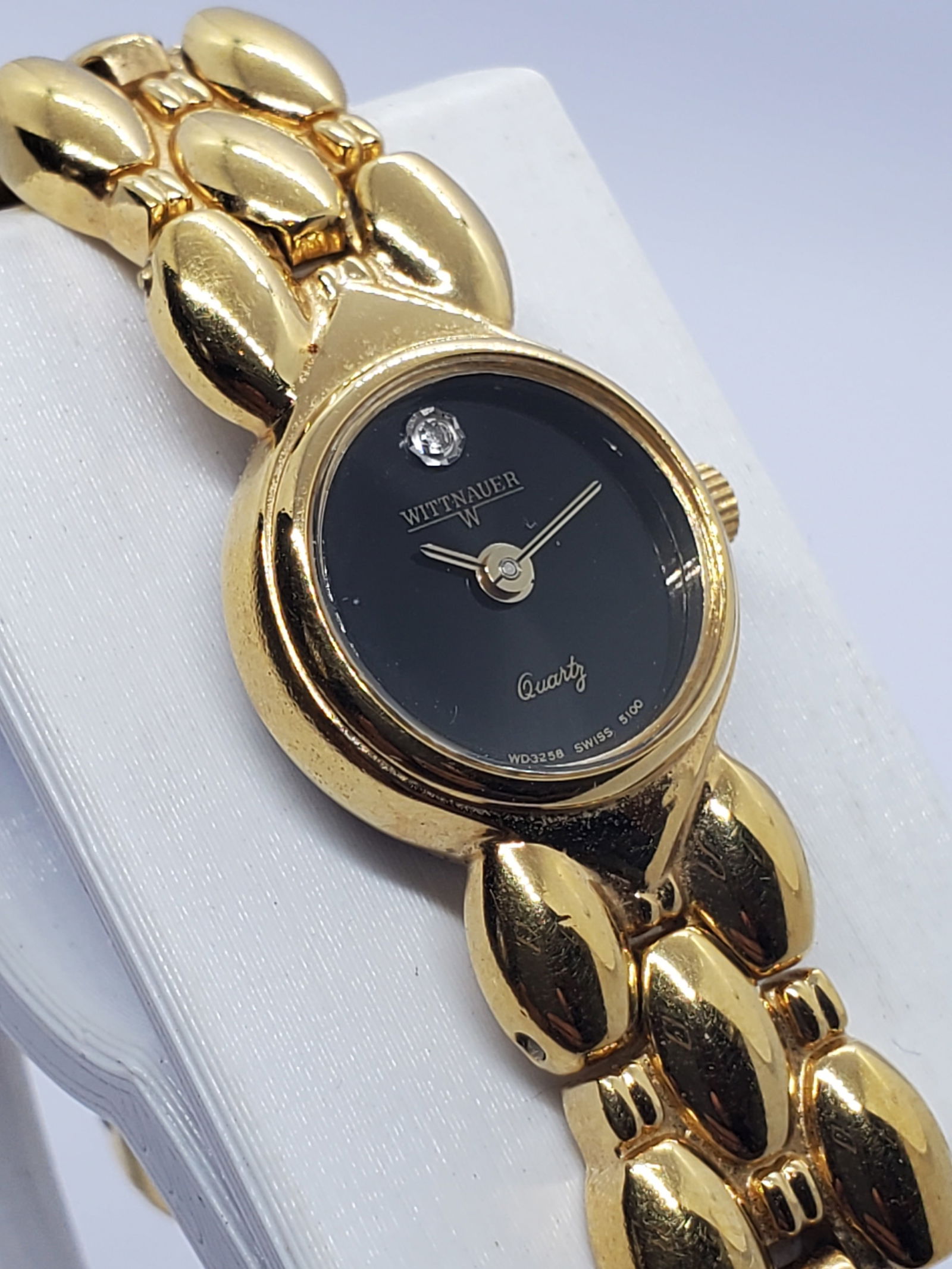 Wittnauer WD3258 Elegant Gold Tone Quartz Watch With Black Dial Stone, 1980s: This refined Wittnauer WD3258 quartz dress watch reflects classic elegance and understated prestige, designed for graceful everyday wear and formal occasions alike. Featuring a gold plated case paired