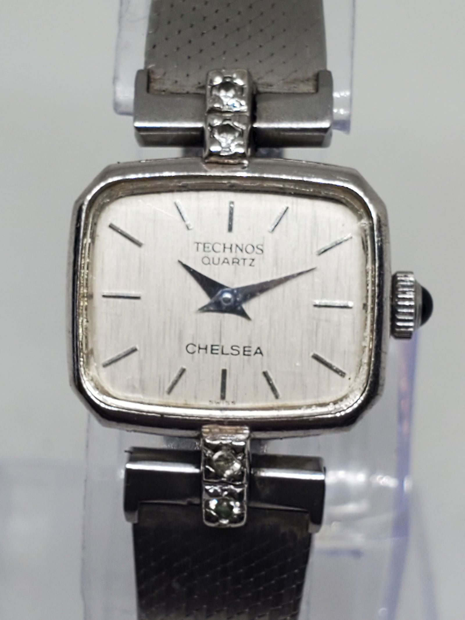 Vintage Technos Chelsea Quartz Womens Watch w/ Diamonds, 1970s: This elegant Technos Chelsea womens watch, reference 709020, combines timeless sophistication with the reliable performance of Swiss quartz craftsmanship. Featuring a silver tone case and a brushed si