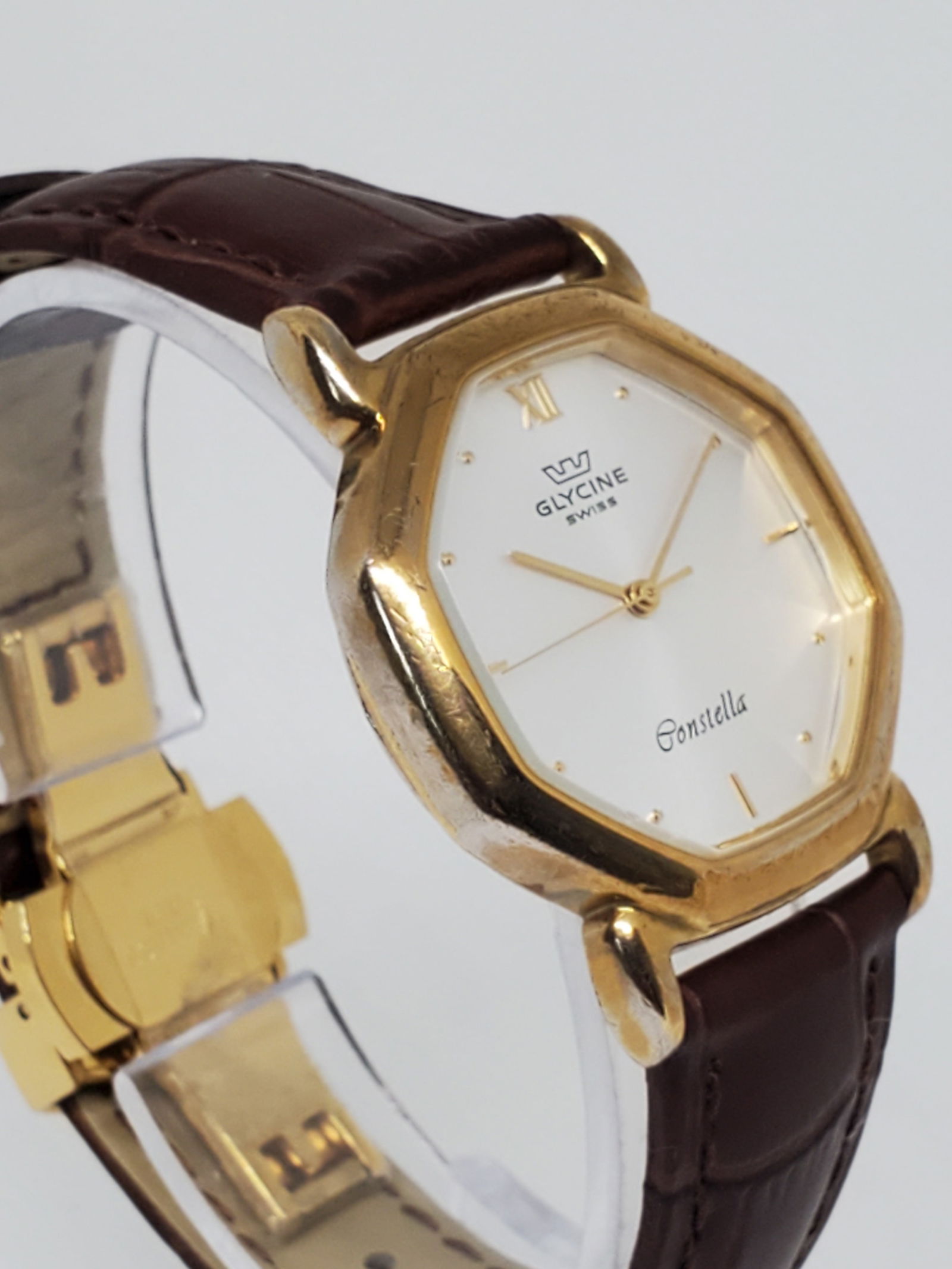 Glycine Constella Gold Plated Octagonal Watch, 1990s: Step into the world of refined luxury with the Glycine Constella, a watch that perfectly blends elegance with the prestige of Swiss craftsmanship. This exquisite timepiece features a striking 30mm oct