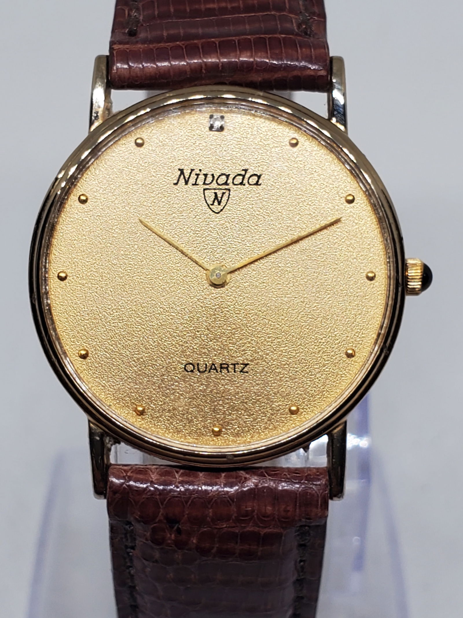 Vintage Nivada Grenchen Gold Plated Ladies Dress Watch Quartz 29mm Pristine, 1990s , Working: This elegant Nivada Grenchen dress watch showcases the refined simplicity and prestige that made the brand a Swiss favorite among collectors. Crafted with a beautifully textured gold tone dial and a s