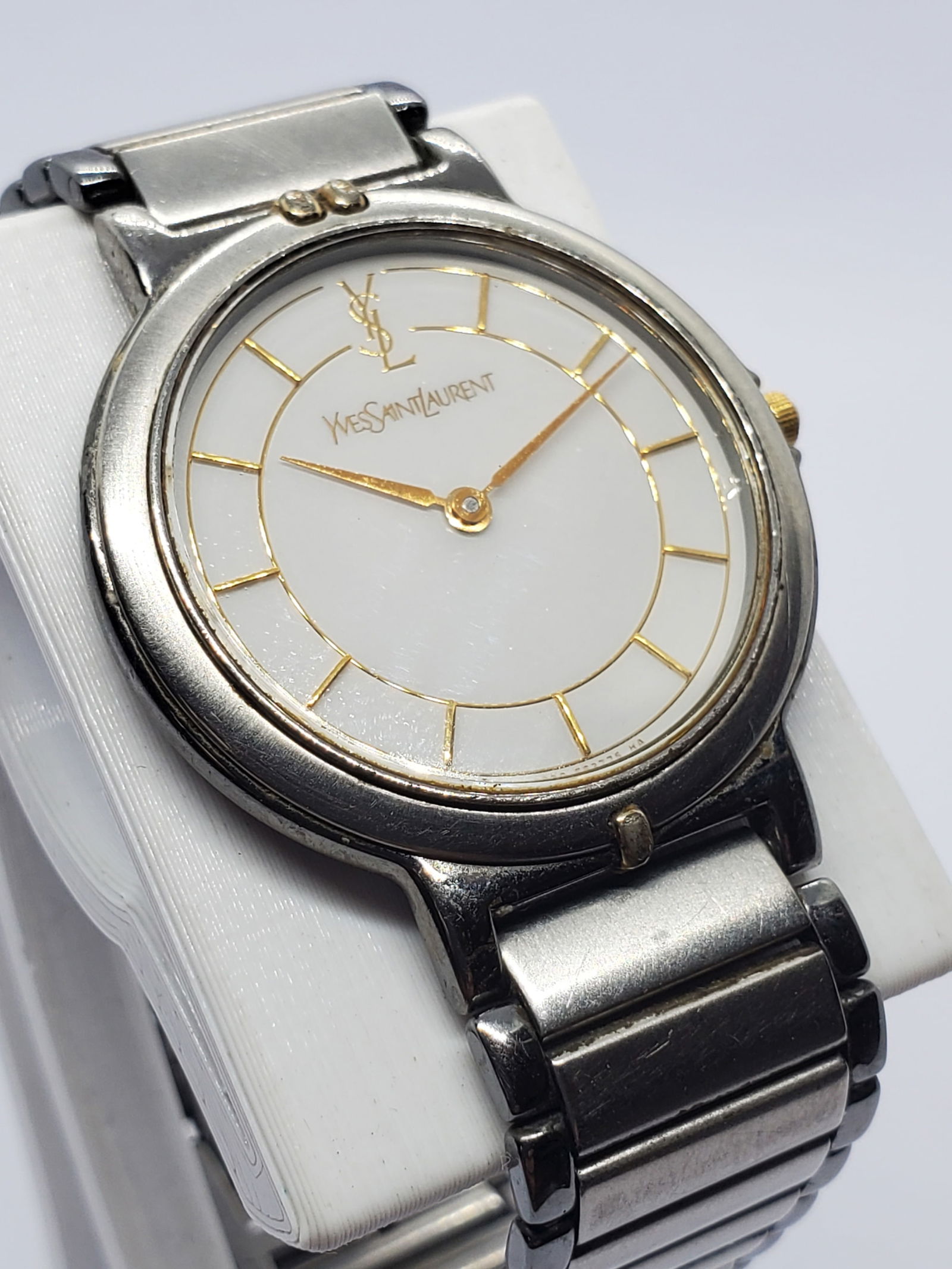 Vintage YSL Quartz Dress Watch Silver and Gold Ivory Dial 29mm Classic Luxury, 1990s, Working: This elegant Yves Saint Laurent YSL model 5126 8010 quartz dress watch embodies refined Parisian luxury with a timeless design that remains effortlessly wearable today. Featuring a silver tone case ac