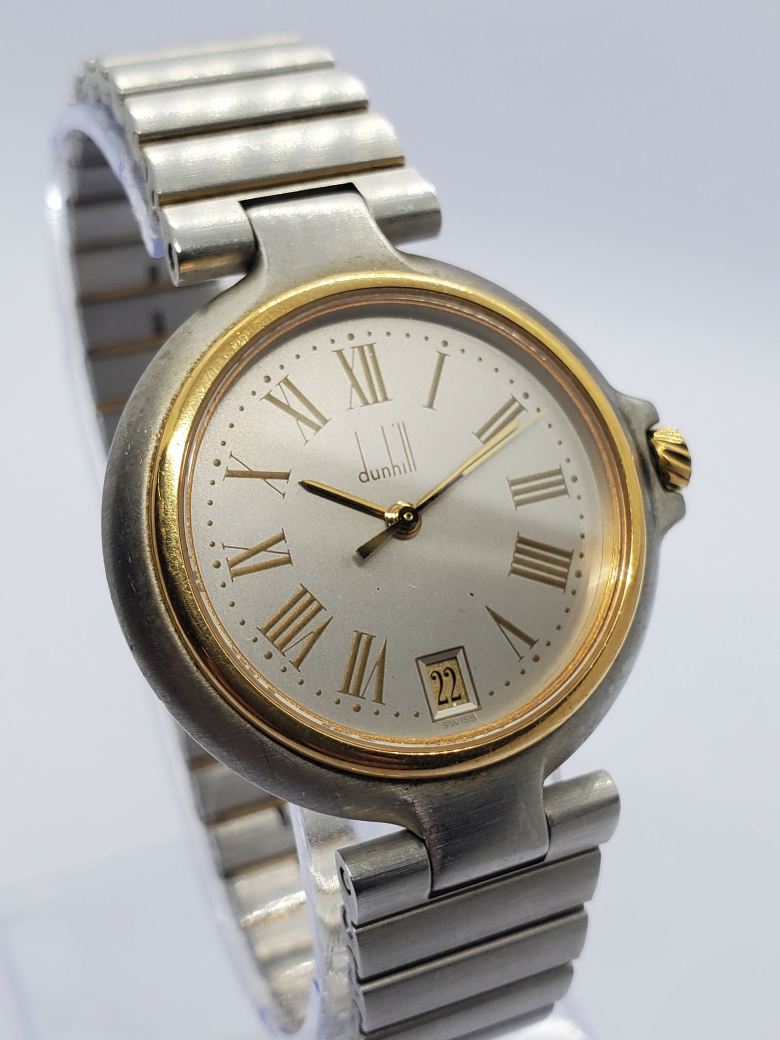 Vintage Dunhill Classic Quartz Dress Watch Two Tone Roman Dial Swiss, 1990s, Working: This refined Dunhill Classic TP0V quartz watch exemplifies understated elegance and enduring prestige, blending a silver tone case with a gold plated bezel for a timeless two tone look that transition