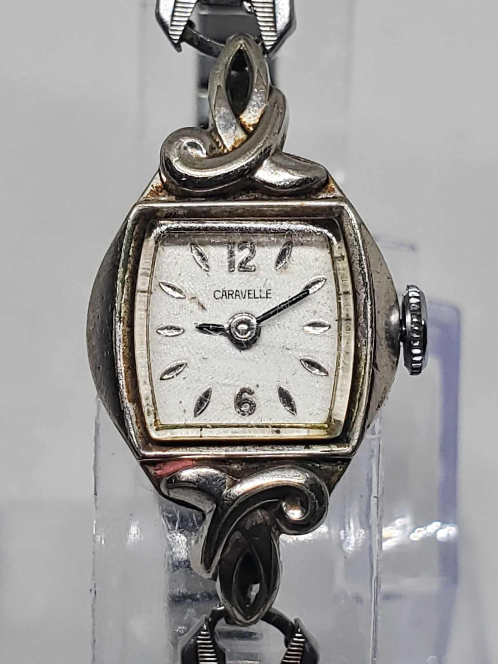 Vintage Caravelle by Bulova Ladies Manual Wind Watch Elegant Silver Design 17Jewels, 1960s, Working: This vintage Caravelle by Bulova ladies dress watch embodies timeless refinement and mechanical precision. Featuring a silver-tone case with delicate sculpted lugs and a white dial with raised hour ma