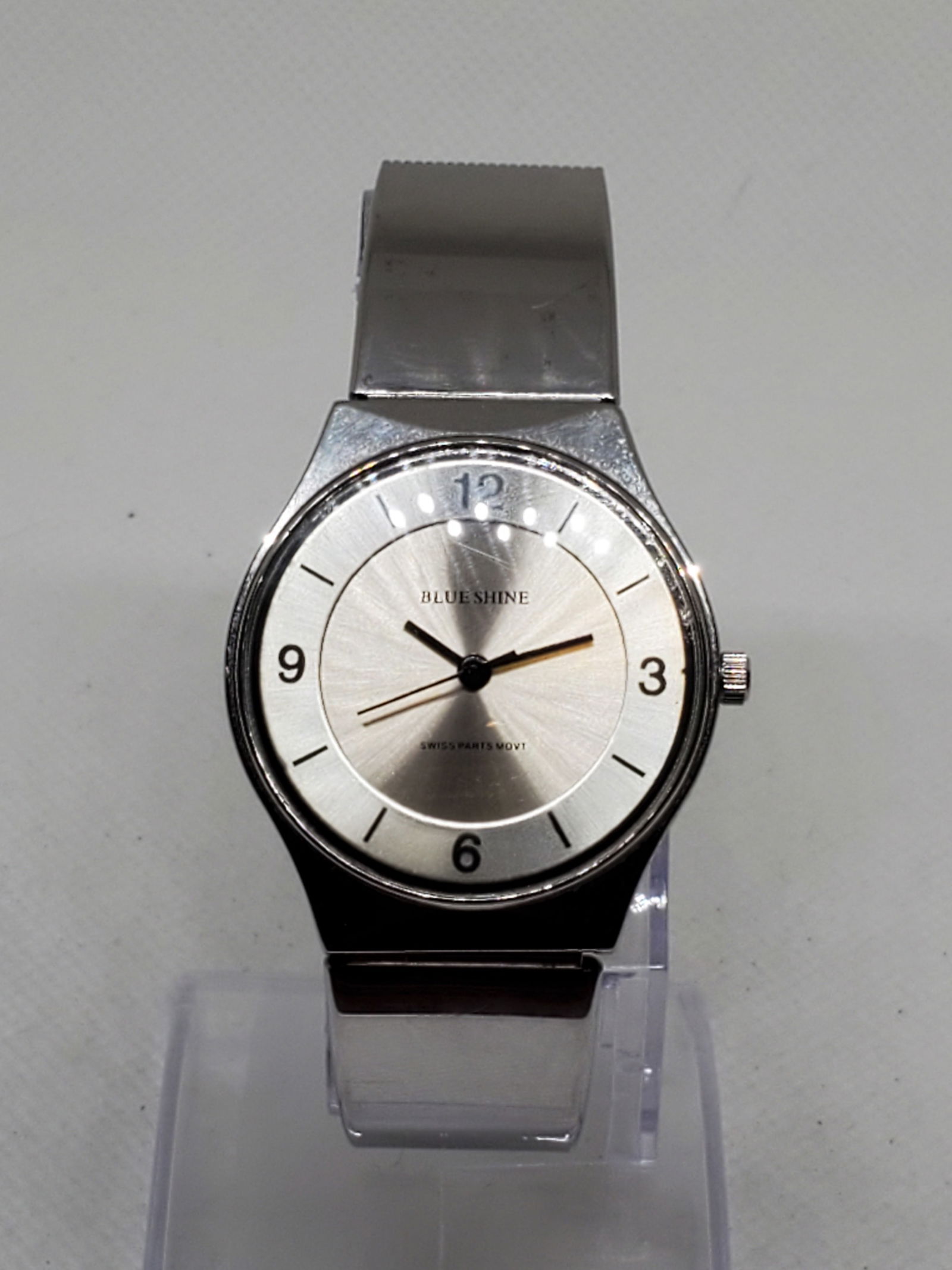 Blue Shine Quartz Silver Mesh Watch Minimalist Swiss Parts Movement 32mm, 2000s, Working: This Blue Shine Quartz wristwatch exudes sleek minimalist elegance with a durable silver tone case and a starburst silver dial that captures light beautifully. Its clean design and black numeral hour