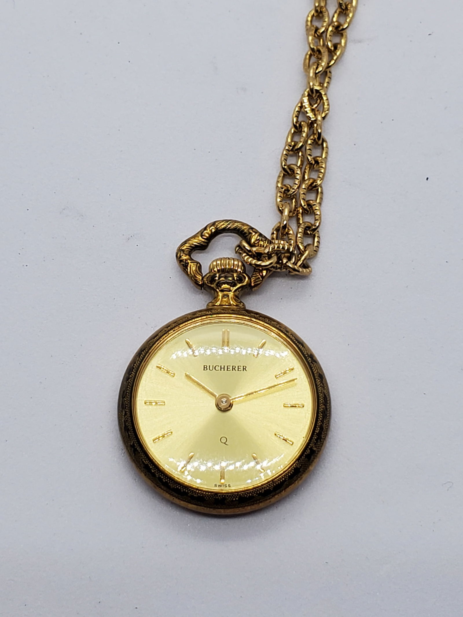 Bucherer Gold Pendant Watch With Necklace Swiss Quartz, 24mm, 1980s, Working: This elegant Bucherer pendant watch exemplifies Swiss craftsmanship and timeless sophistication, combining jewelry and horology in a refined dress accessory ideal for collectors and vintage enthusiast