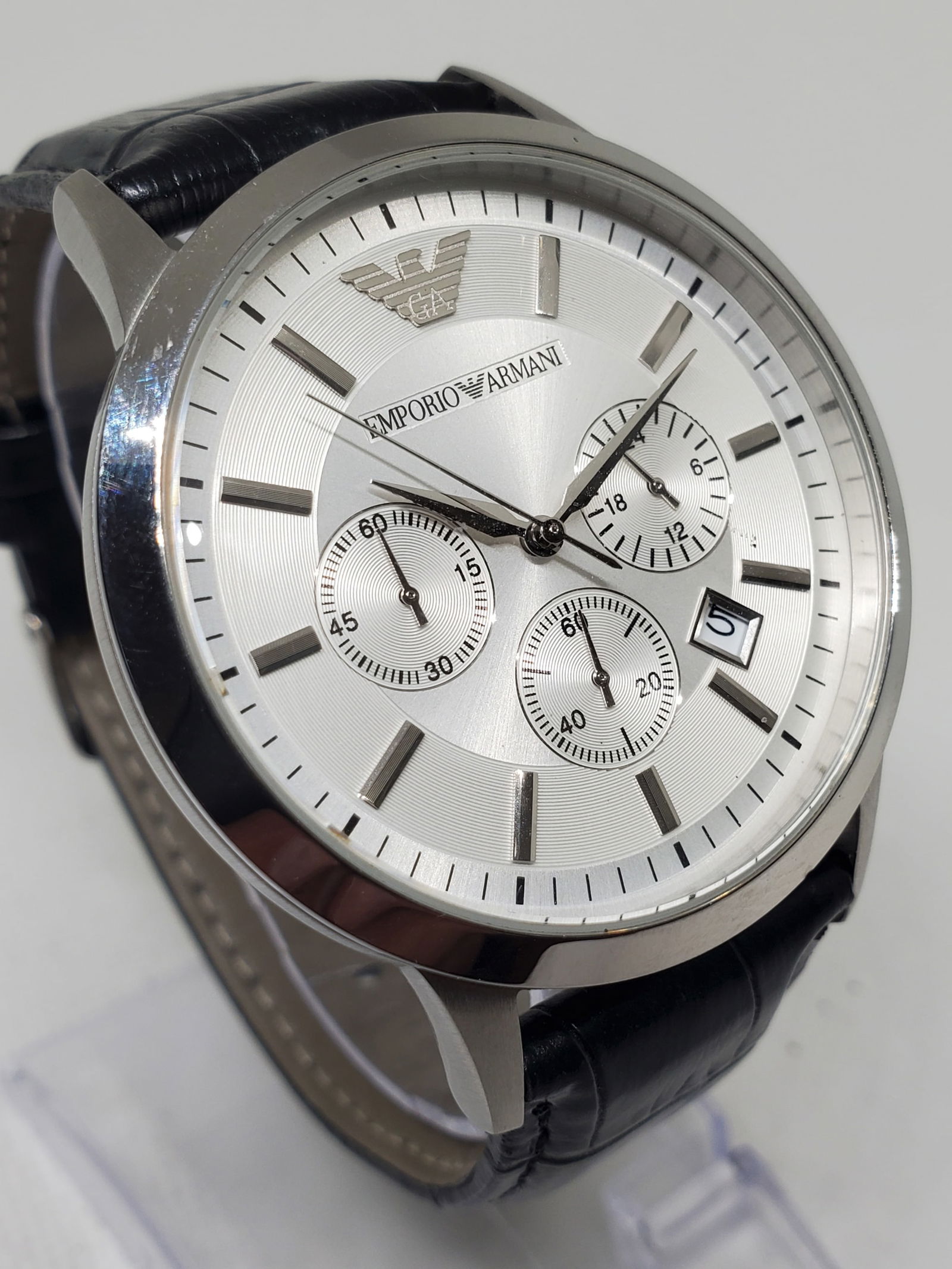 Emporio Armani AR-2458 Silver Chronograph Watch ? Quartz Precision & Elegant Design, 2015, Working: This Emporio Armani AR-2458 exemplifies refined Italian design with a touch of modern luxury. Its silver-tone stainless-steel case and matching dial create a sleek, monochromatic look, complemented