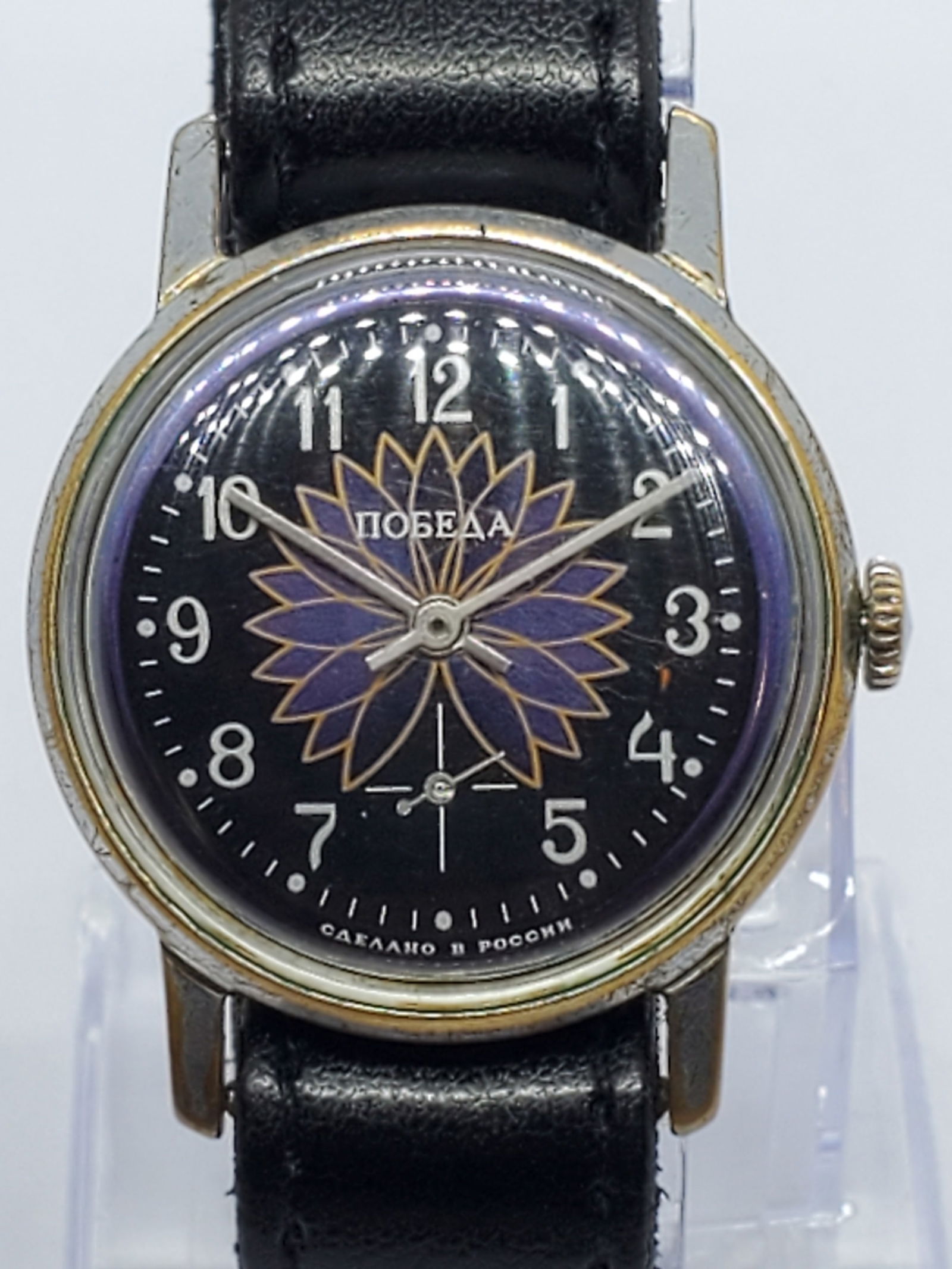 Vintage Pobeda USSR Manual Watch Black Floral Dial Caliber 2602 34 mm, 1980s, Working: Vintage Pobeda Victory manual wind watch featuring a silver tone case and a striking black dial with a stylized purple floral motif (the flower symbolizes rebirth or victory which is associated to