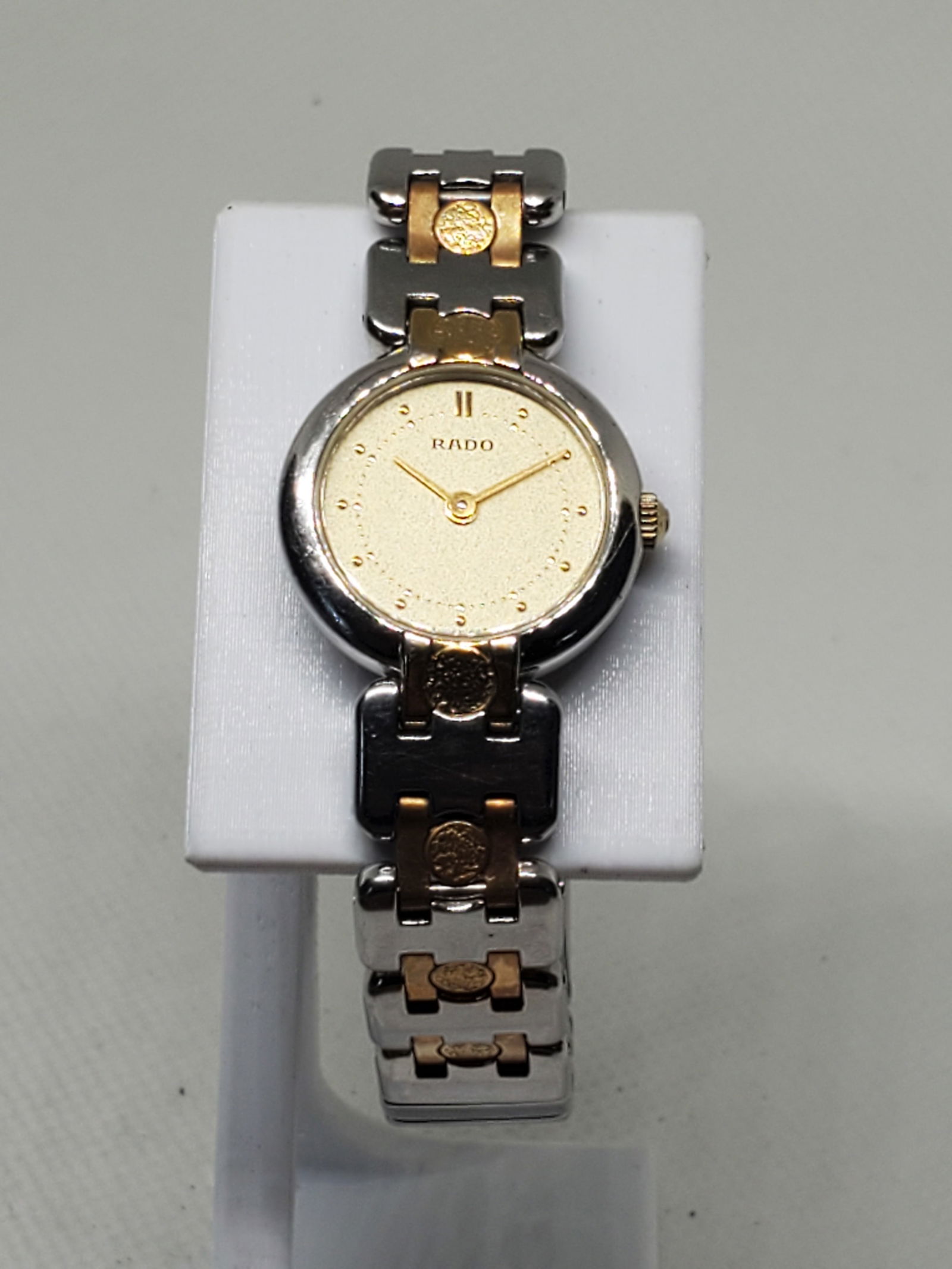 Rado Dual Tone Gold Silver Watch, 1980s, Working: Experience the refined luxury of the Rado 153.3569.2 (running), a timepiece that effortlessly combines elegance, durability, and Swiss precision. This quartz powered watch boasts a silver tone case pa