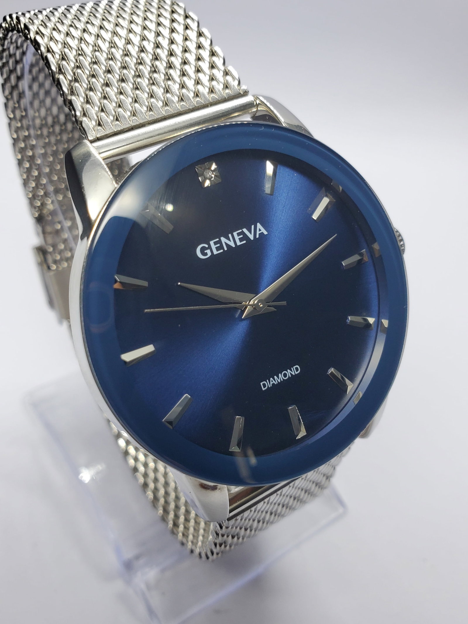 Geneva Diamond Blue Dial Watch, 42mm, New in Box, Working: This Geneva KHA0001SL wristwatch embodies a blend of modern elegance and practical style, perfect for both formal and casual settings. Featuring a sleek silver tone case with a deep blue dial, it exud