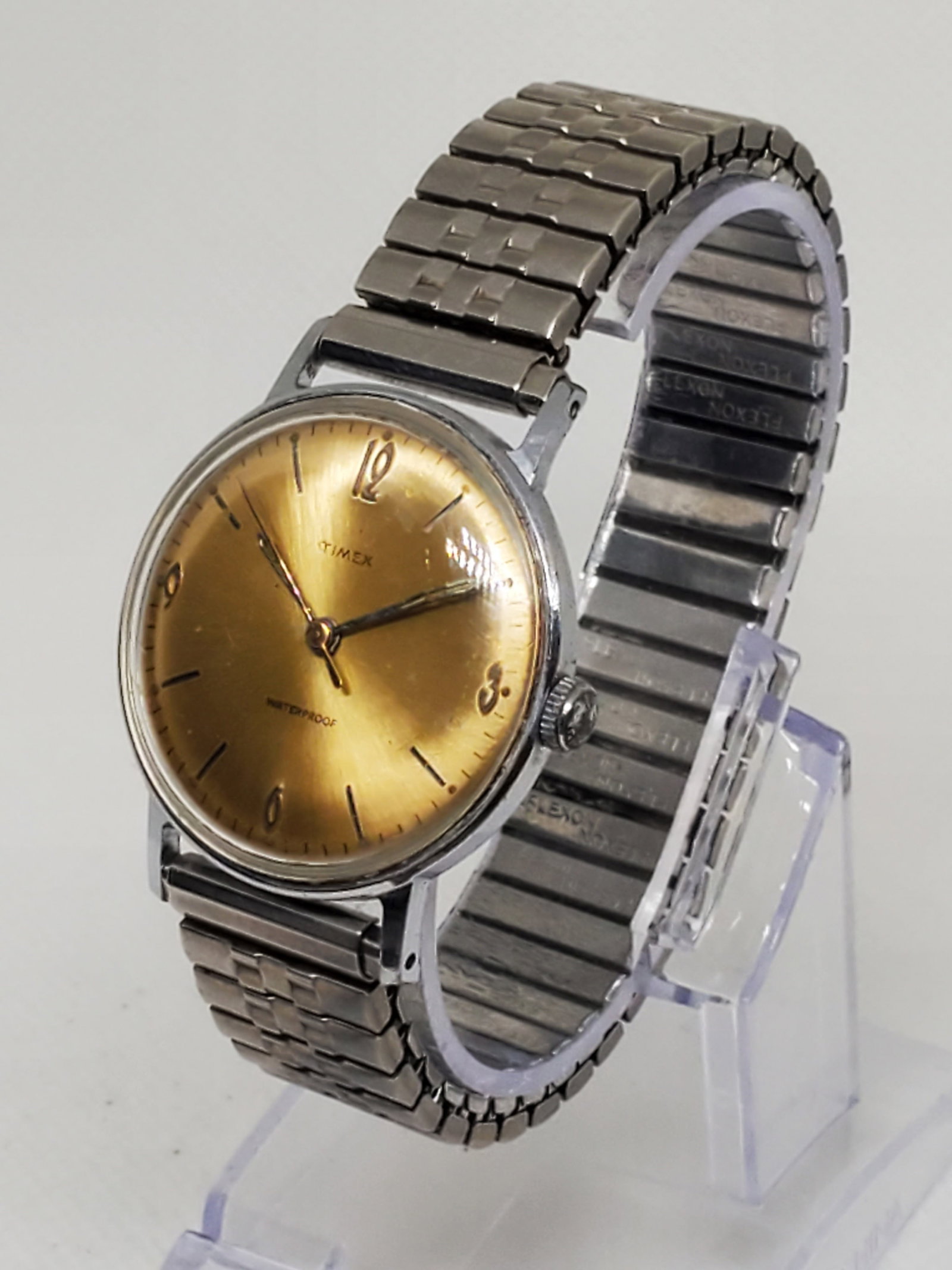 Vintage Timex Manual Wind Watch, Gold Sunburst Dial 33mm , Working: This vintage Timex Waterproof manual wind mens watch combines timeless elegance with the reliable craftsmanship that made Timex one of America?s most enduring watchmakers. Featuring a silver-tone case