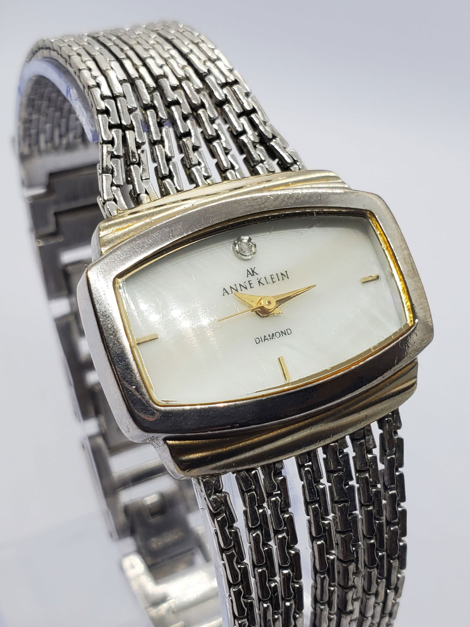 Anne Klein Diamond Mother of Pearl Dress Watch 30 mm x 25 5mm, 1990s, Working: This elegant Anne Klein model 10/8401 quartz dress watch showcases the brand?s signature blend of refined fashion and everyday sophistication. Featuring a silver tone case paired with a luminous mothe