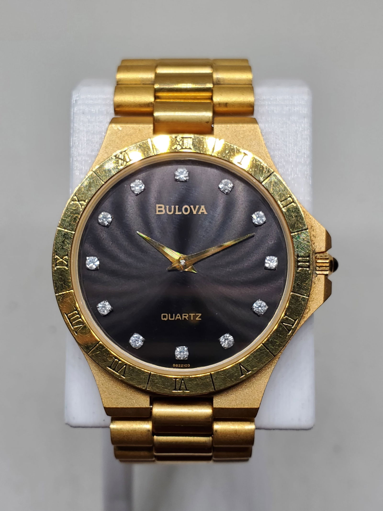 Bulova Longchamp Gold Plated Dress Watch Black Dial, Crystal Markers, Roman Bezel, 1990s, Working: This elegant Bulova Longchamp model 159872 embodies the prestige and refined styling the brand has delivered since Joseph Bulova founded the company in New York in 1875, becoming one of America?s most
