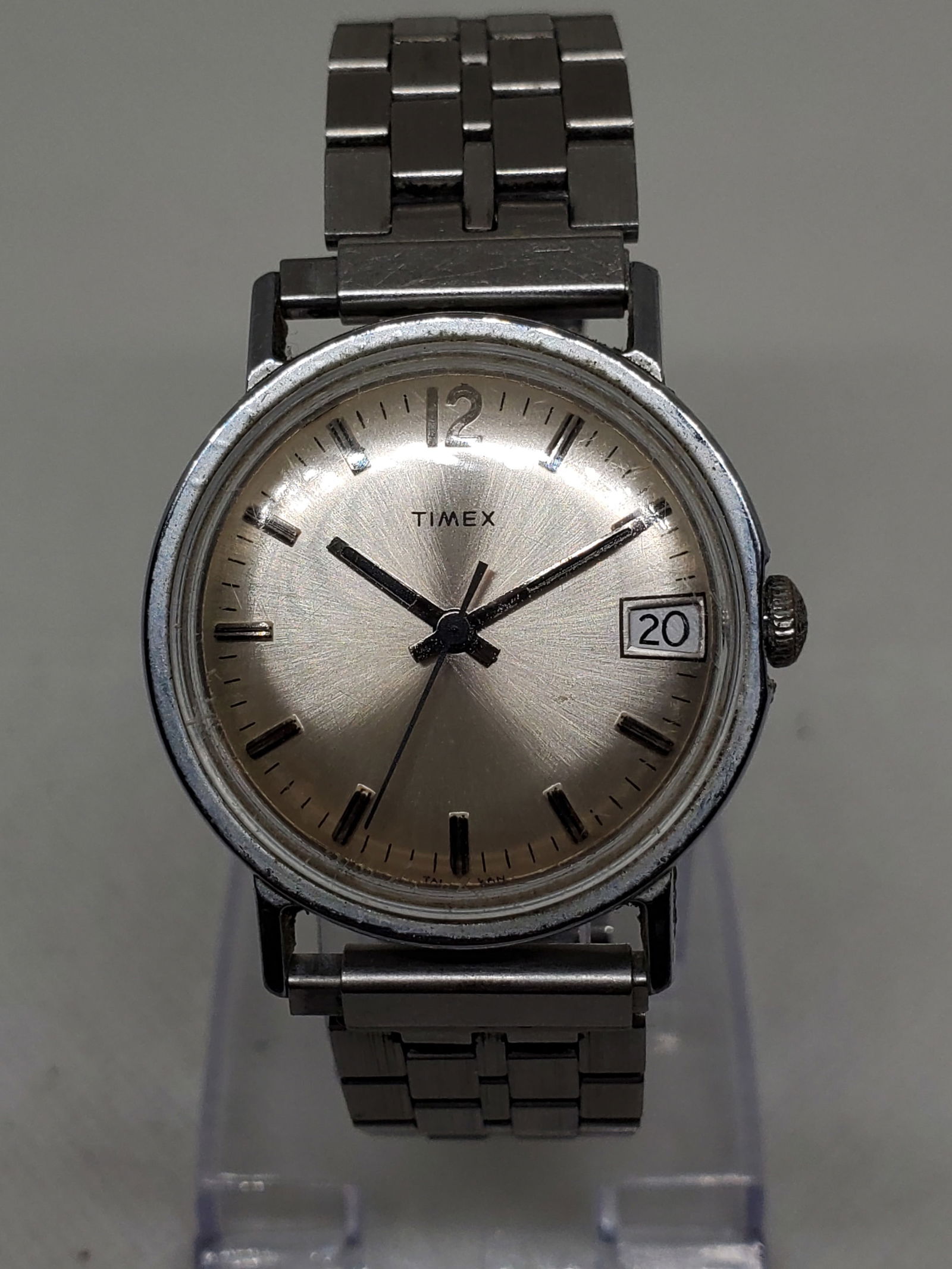 Vintage Timex Manual Watch 34mm, late 1970s, Working: This vintage Timex Taiwan model offers timeless charm with a silver tone case and an elegant silver starburst dial accented by a practical date window, combining everyday functionality with classic st
