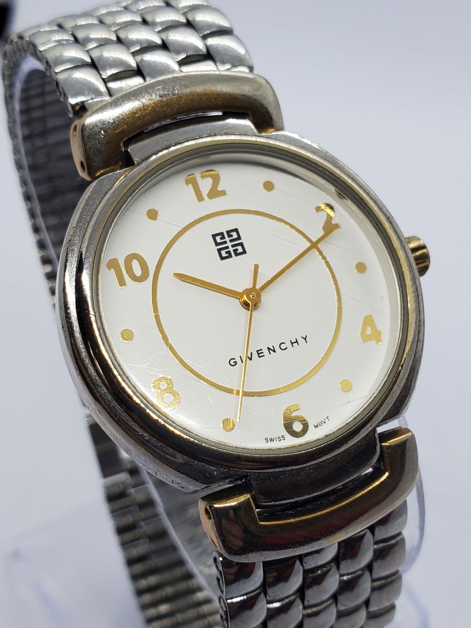 Vintage Givenchy Life Swiss Quartz Dress Watch 32 mm White Dial Gold Accents, 1990s, Working: Elegant and refined, this Givenchy Life 04 18 XV quartz dress watch showcases the timeless prestige of the Givenchy name, a brand founded by Hubert de Givenchy in 1952 in Paris and celebrated for its