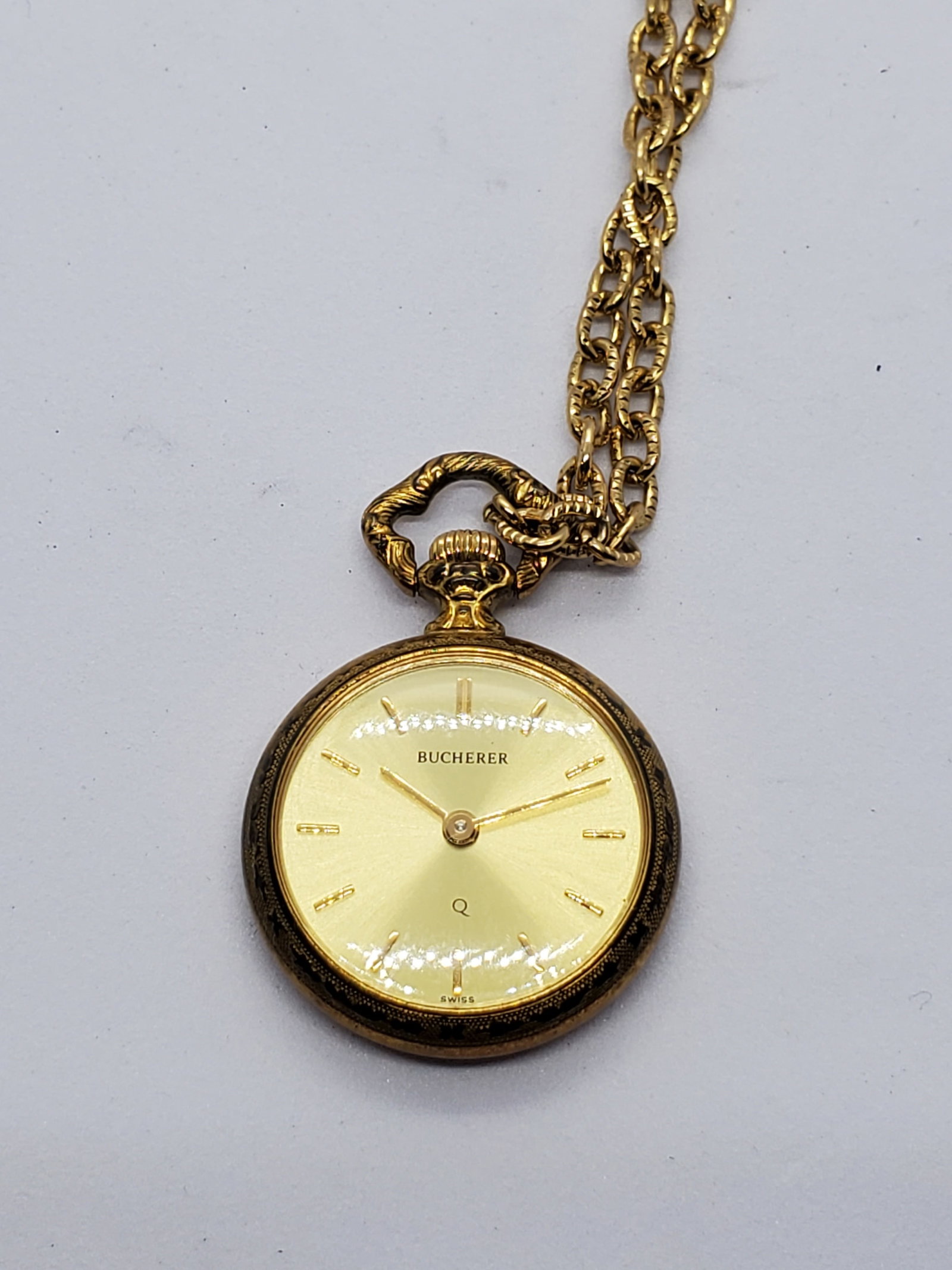 Bucherer Gold Pendant Watch With Necklace Swiss Quartz, 24mm, 1980s, Working: This elegant Bucherer pendant watch exemplifies Swiss craftsmanship and timeless sophistication, combining jewelry and horology in a refined dress accessory ideal for collectors and vintage enthusiast