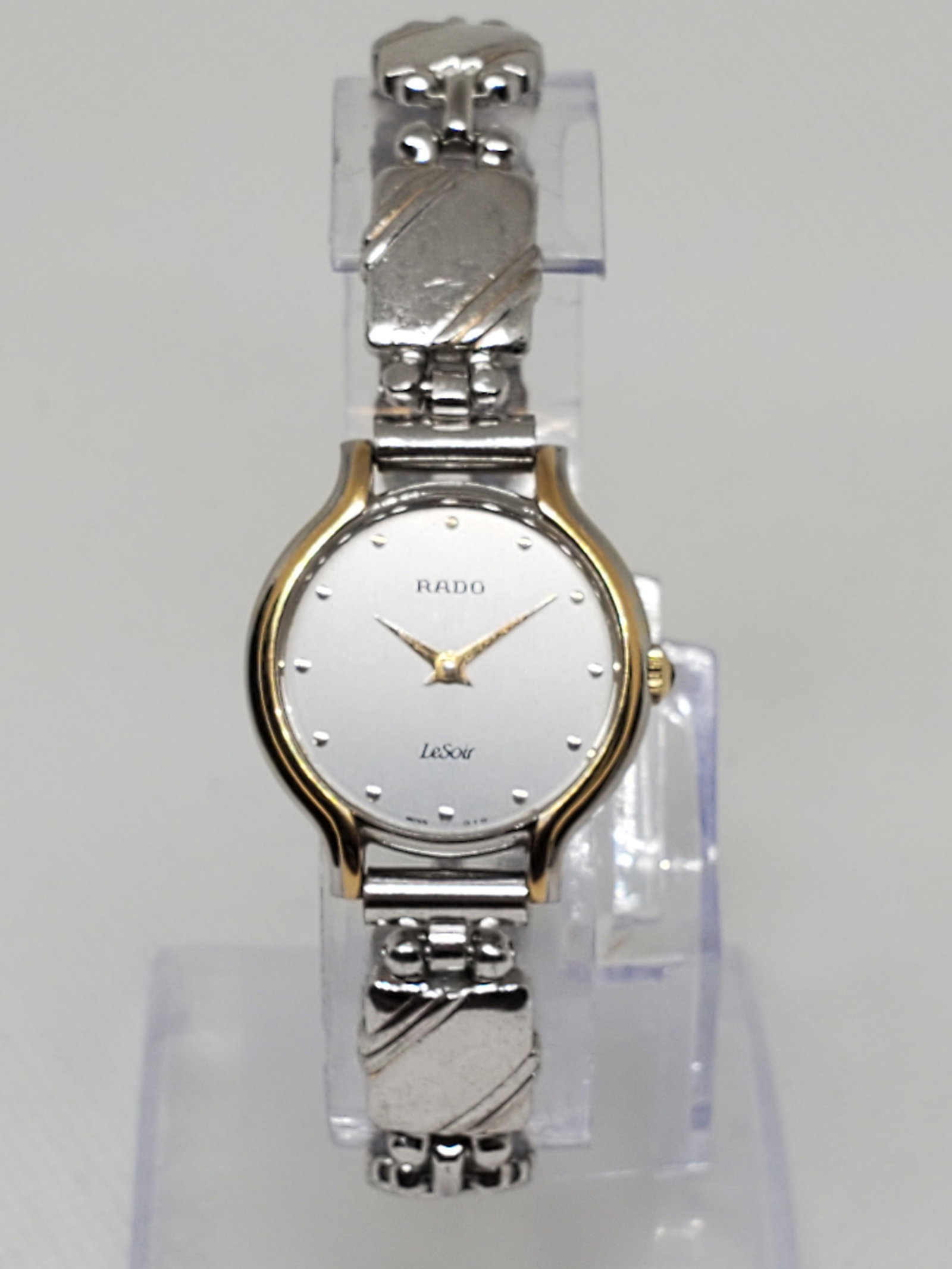 Rado Le Soir Dual Tone Ladies Watch, 1990s, Working: This Rado Le Soir (The Evening) timepiece embodies elegance and prestige, crafted with a refined dual tone case and a minimalist silver dial. Powered by a precise quartz movement, it offers reliabilit
