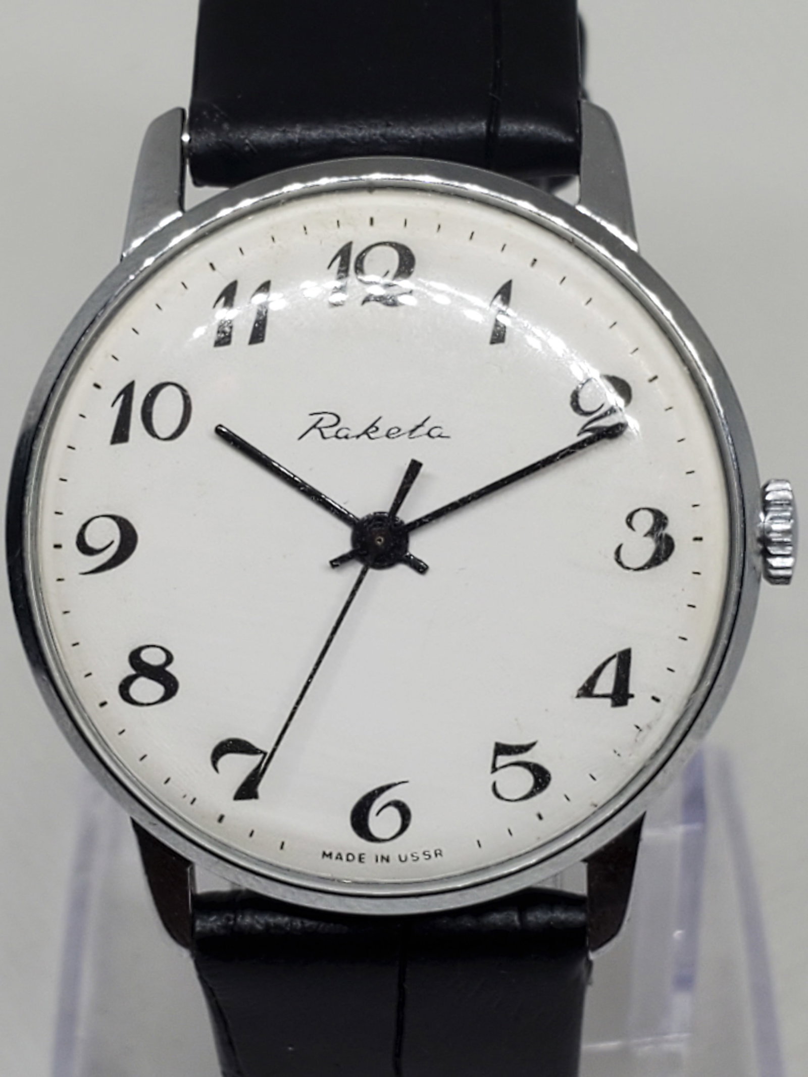 Vintage Raketa USSR Manual Men?s Watch 34mm, Working: Elegant Raketa manual watch featuring a silver tone case 34mm, white dial, and 7" leather bracelet. A symbol of Soviet precision, Raketa was founded in 1961 at the Petrodvorets Watch Factory, with roo