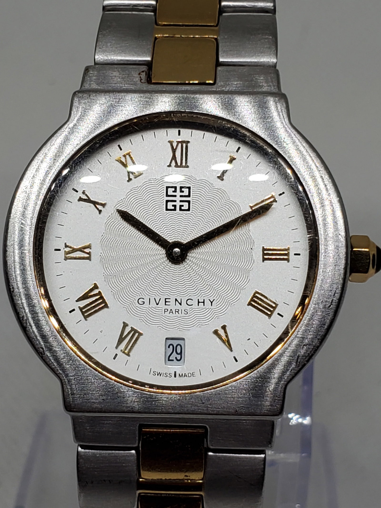 Elegant Givenchy 301418 Swiss Made Dual Tone Dress Watch 32mm Classic Style, 1990s, Working: This sophisticated Givenchy 301418 embodies the elegance and prestige of the iconic French fashion house founded by Hubert de Givenchy in 1952 in Paris, a brand celebrated for its refined aesthetics a