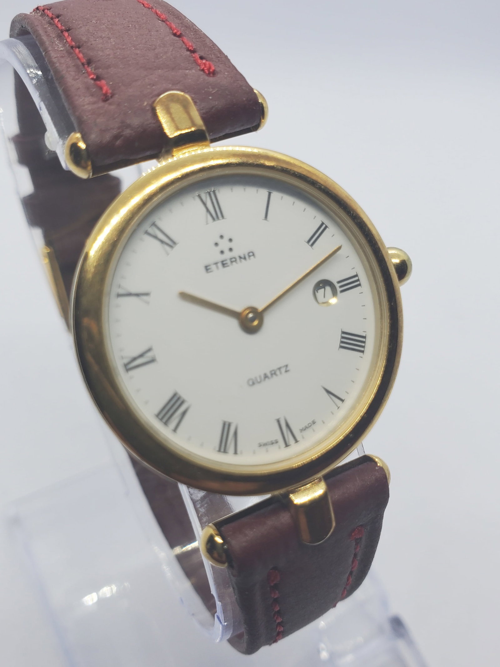 Elegant Eterna Classic Gold Plated Dress Watch Swiss Vintage, 26 mm, 1990s , Working: Elegant and refined this Eterna Classic model 250 0882 22 showcases the timeless prestige of Swiss watchmaking with a slim gold plated case and a clean white dial featuring Roman numerals and date dis