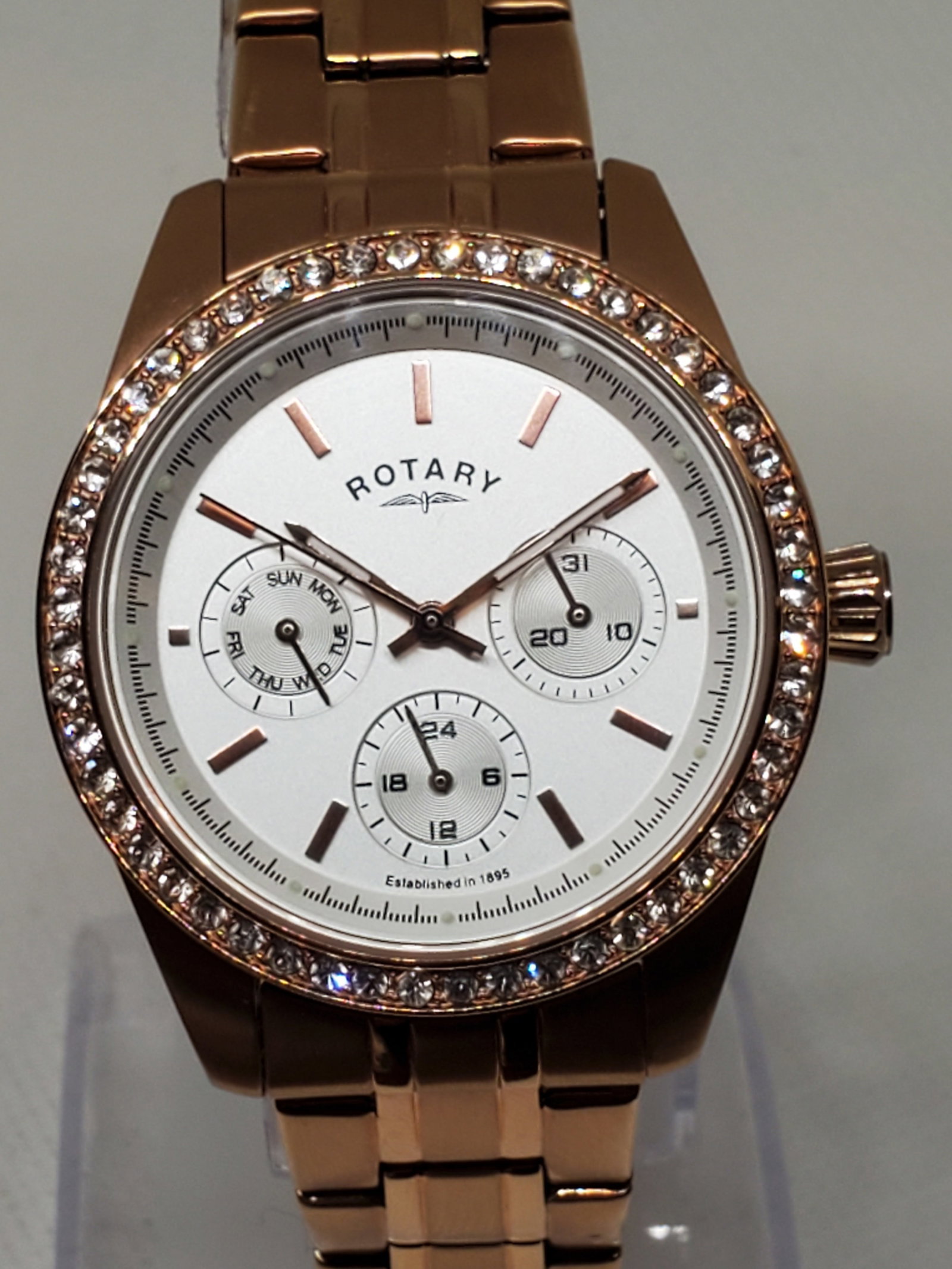 Rotary Rose Gold With Rhinestone Bezel Watch, 2010s, Working: Working condition Rotary LB00160/02 Quartz Watch, a stunning piece that effortlessly combines elegance and practicality. This watch features a rose gold case adorned with a sparkling rhinestone bezel,