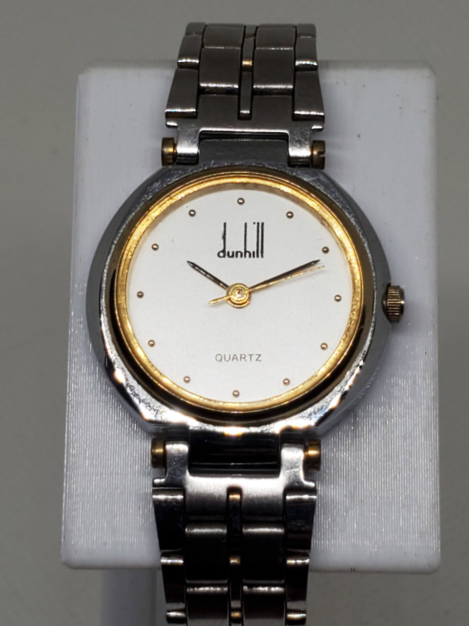 Dunhill Millenium Dual Tone Gold Plated Bezel Watch, 1990s, Working: Experience timeless British sophistication with this Dunhill Millennium Quartz Luxury Watch, a refined piece designed for elegance and versatility. Featuring a dual tone stainless steel and gold tone 